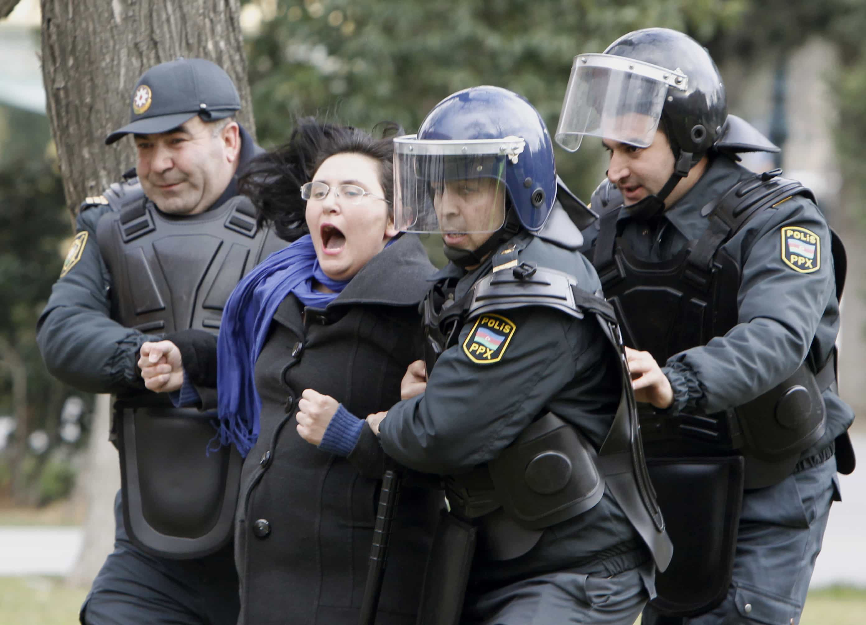 Police arrest a protestor in Baku on 26 January, REUTERS/David Mdzinarishvili