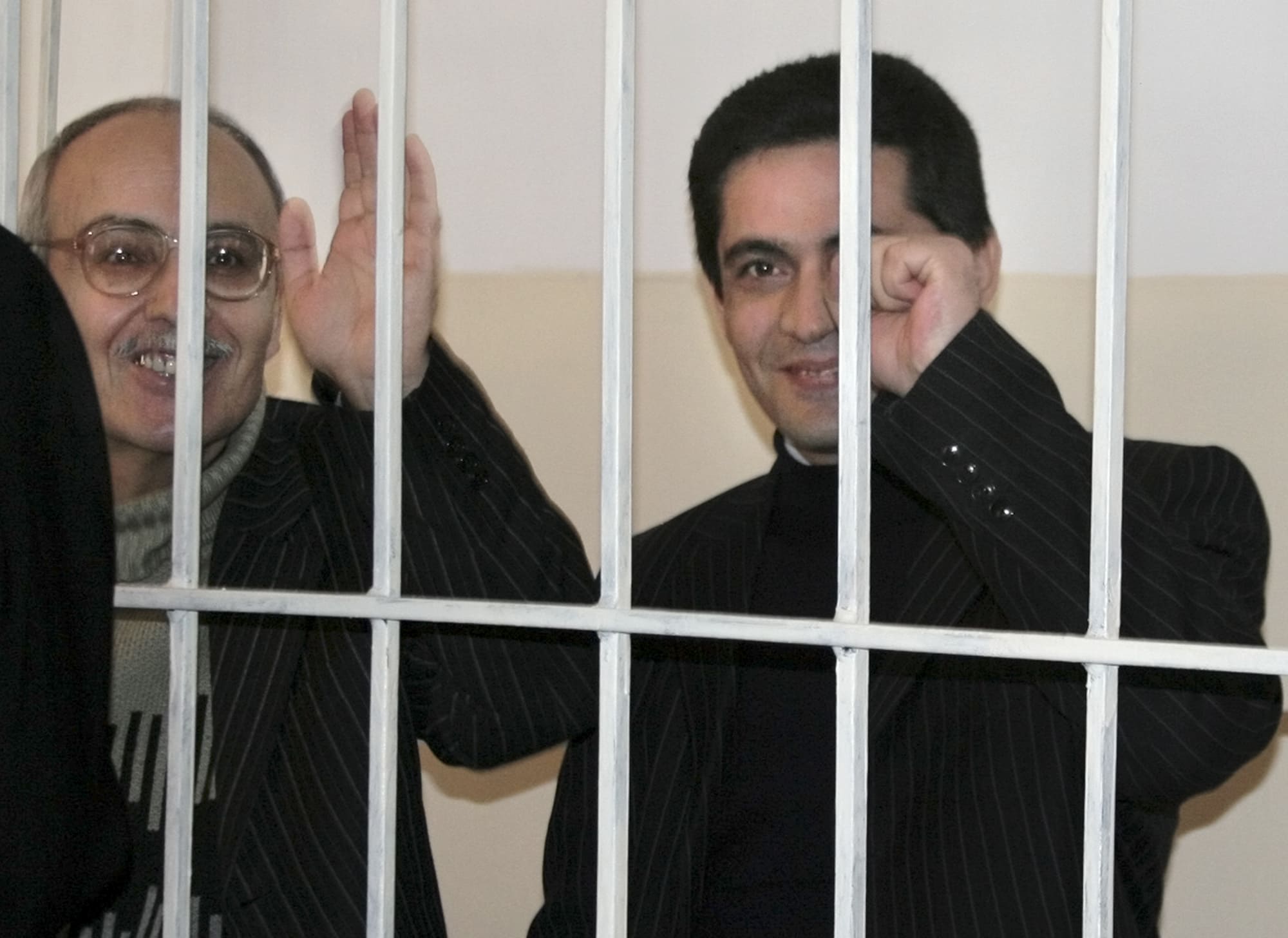Azerbaijani reporter Rafiq Tagi, left, and editor Samir Huseinov of the newspaper Senet seen during a trial in Baku, Azerbaijan, 5 March, 2007. , AP Photo/Aida Sultanova