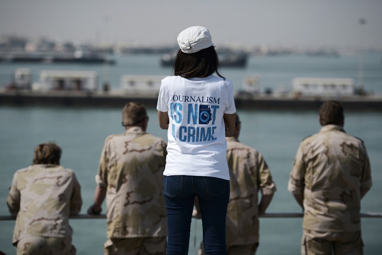 A journalist (c) and sailors from The Netherlands watch training exercises from aboard a U.S. Navy non-combatant vessel, in the Gulf off the coast of Bahrain's capital Manama, 10 April 2016, MOHAMMED AL-SHAIKH/AFP/Getty Images