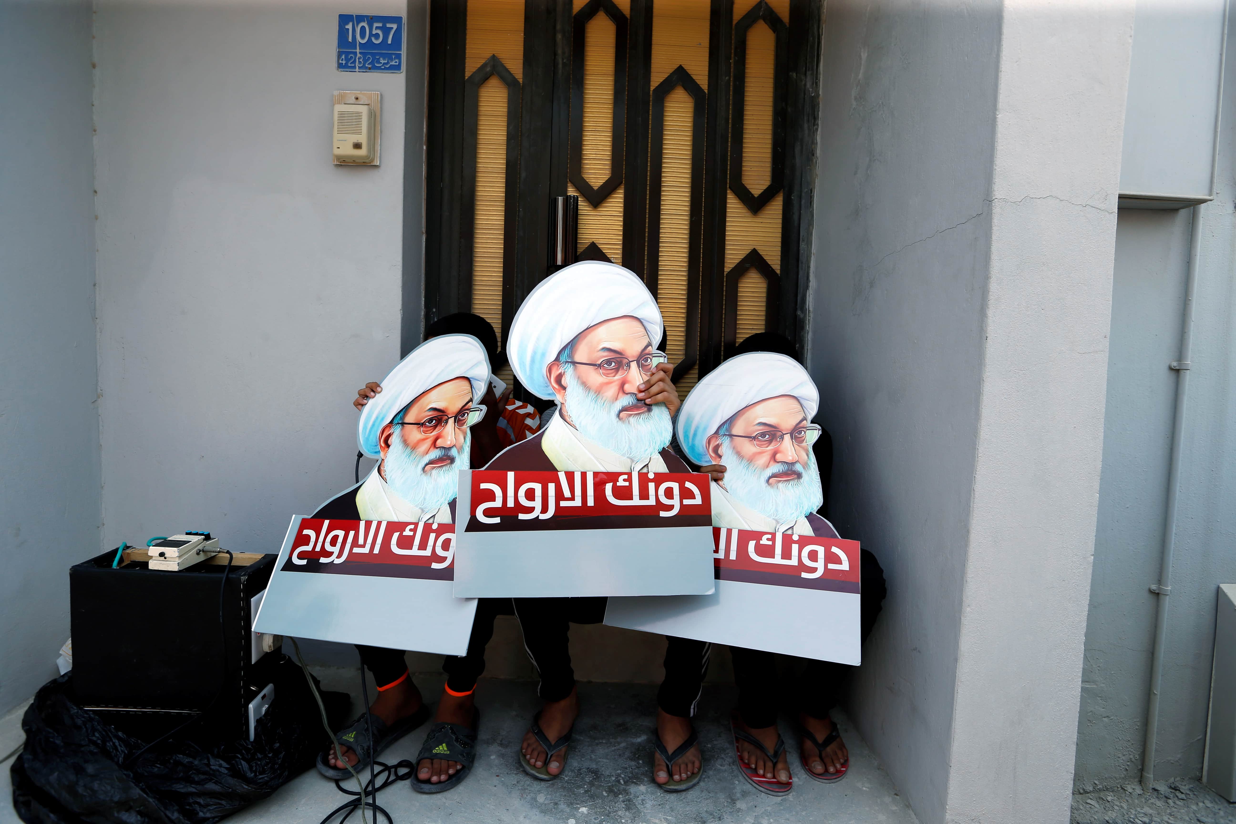 Protesters holding placards with images of Bahrain's leading Shi'ite cleric Isa Qassim, take part in an anti-government protest in the village of Diraz, 12 August 2016, REUTERS/Hamad I Mohammed