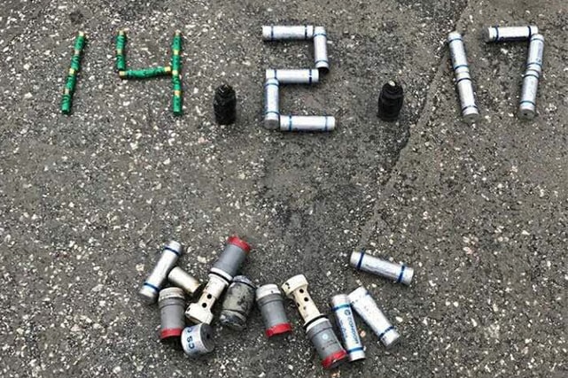 Anniversary date of the Bahrain 14 February 2011 uprising spelled out in gas canisters, Bahrain Center for Human Rights