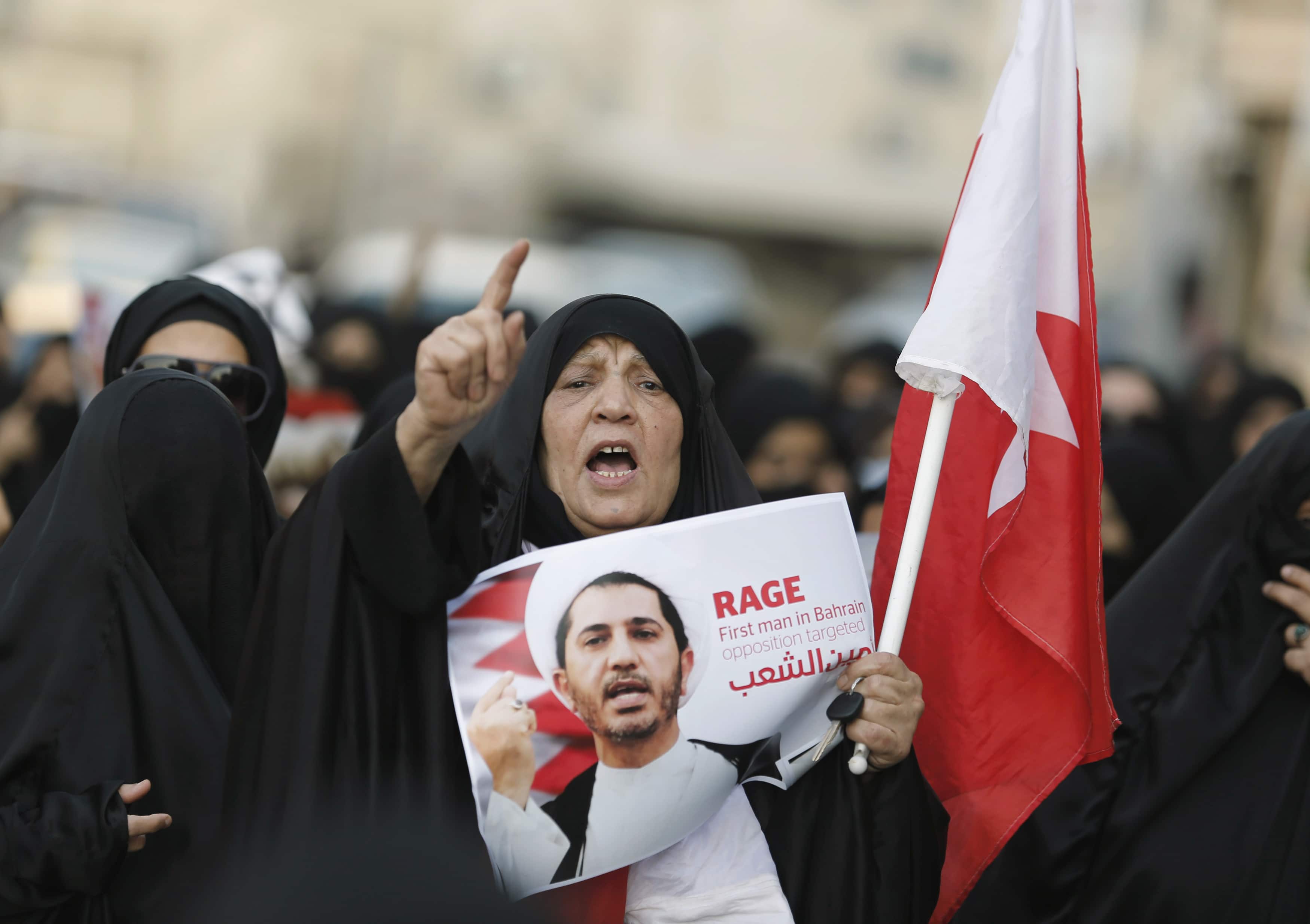 A woman shouts anti-government slogans as she holds a placard with an image of Al Wefaq Secretary-General Sheikh Ali Salman during a demonstration for him in the village of Bilad Al Qadeem, 29 December 2014, REUTERS/Hamad I Mohammed