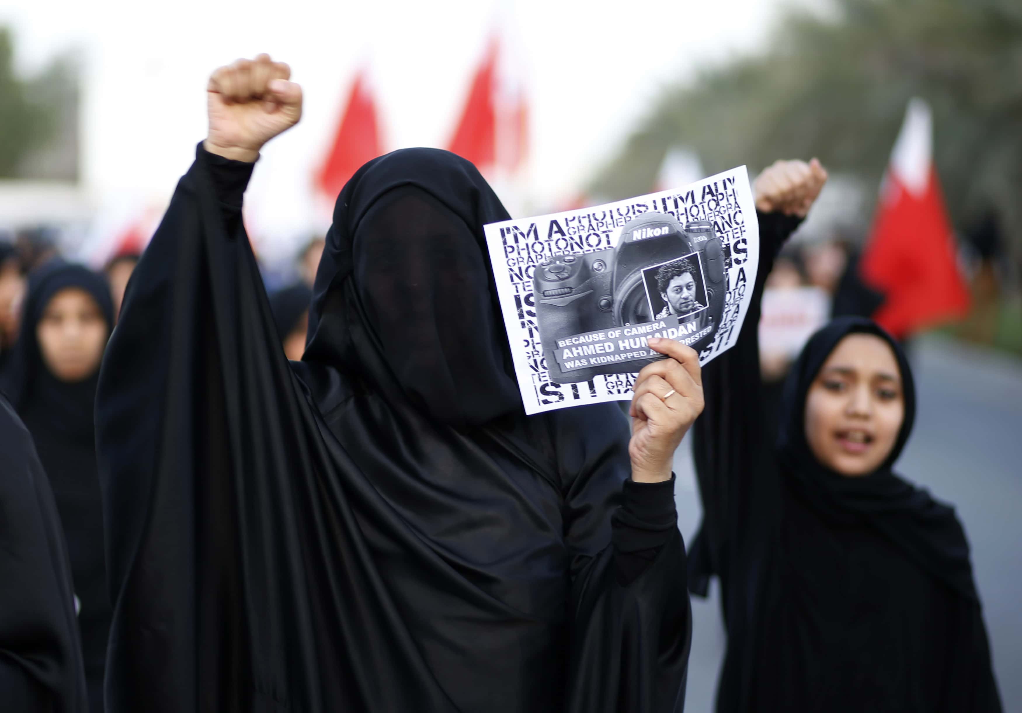 A protester holds a picture of detained photographer Ahmed Humaidan during a demonstration in Bahrain on 13 December 2013, REUTERS/Hamad I Mohammed