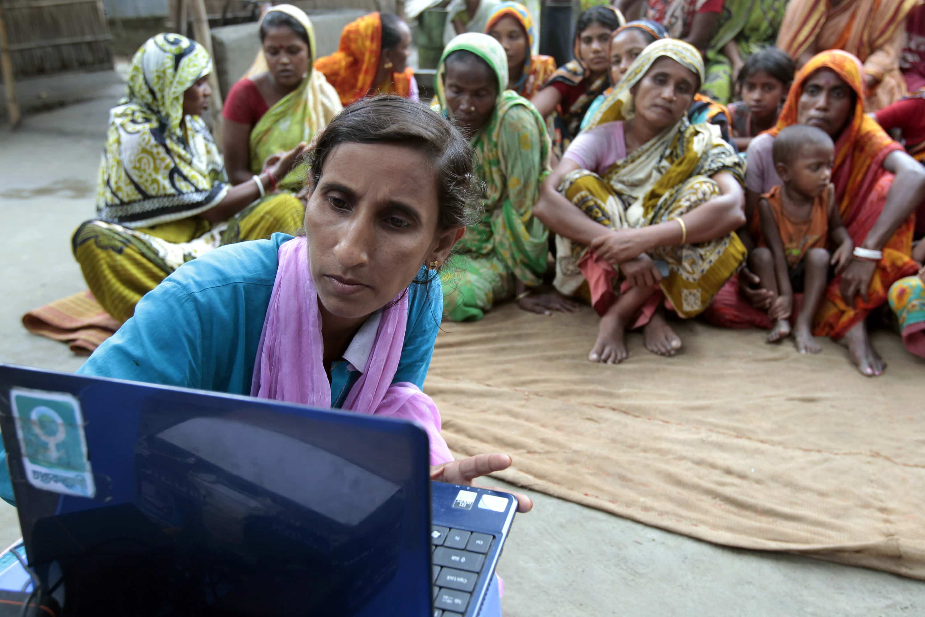 A visiting "Info Lady" brings a laptop and Internet connection to a remote farming village north of Dhaka, Bangladesh, 30 September 2012, AP Photo/A.M. Ahad