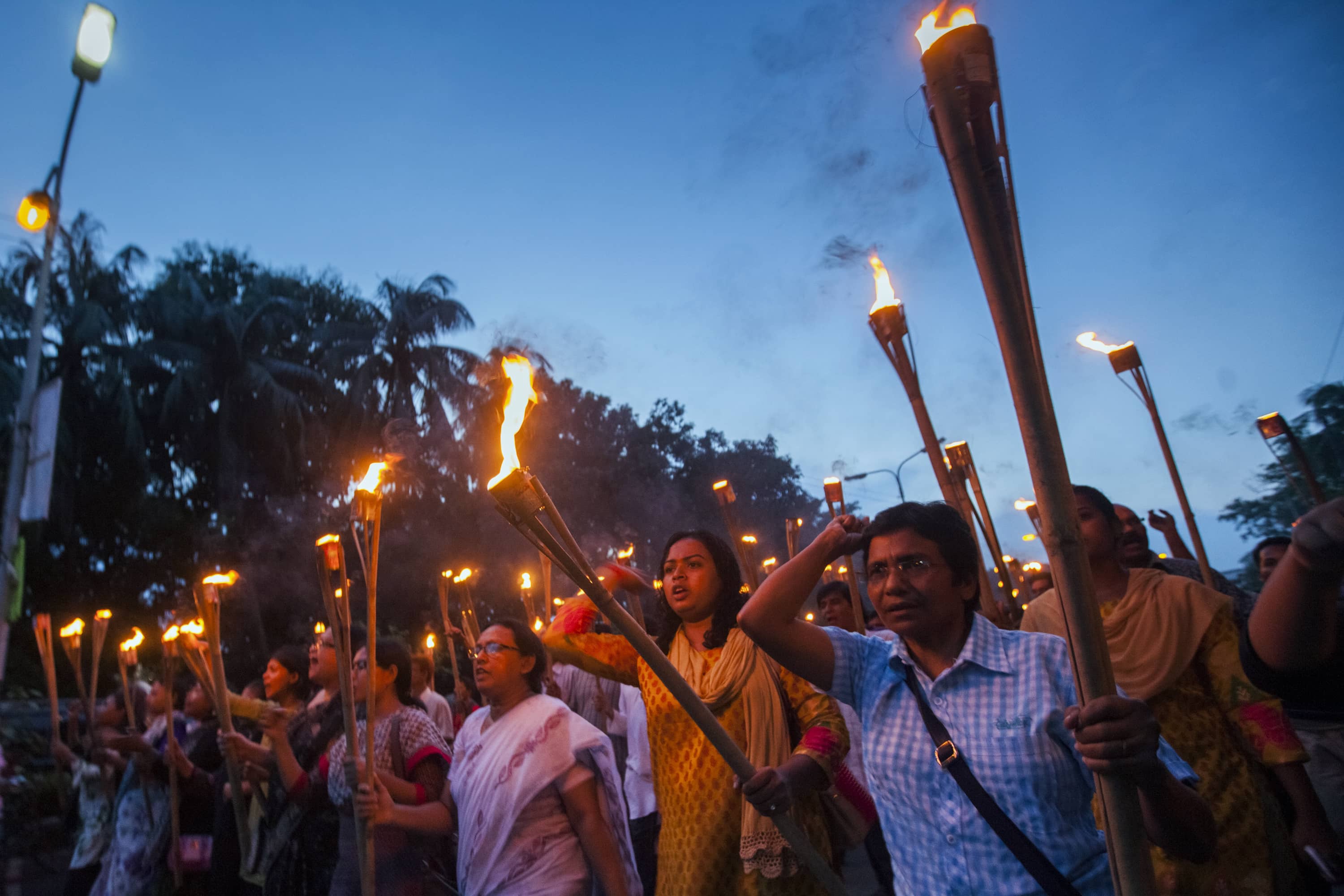 Bangladeshi secular activists participate in a torch rally held to protest against the killing of blogger Niloy Chottopadhay, in Dhaka, 8 August 2015, AP Photo/Rajib Dhar
