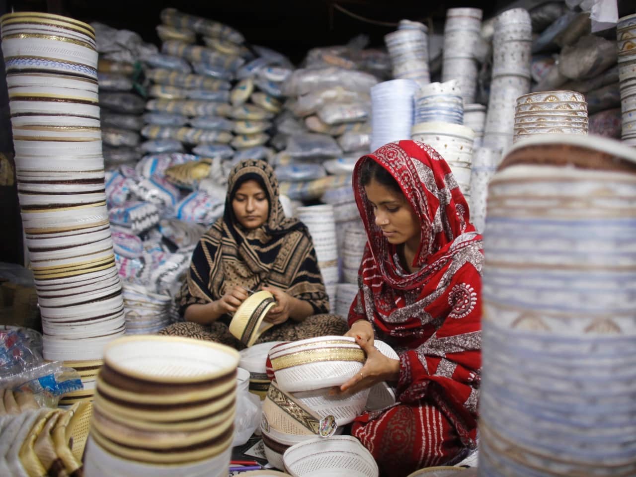 Workers sew prayer caps at a factory in old Dhaka, 10 July 2014, REUTERS/Andrew Biraj