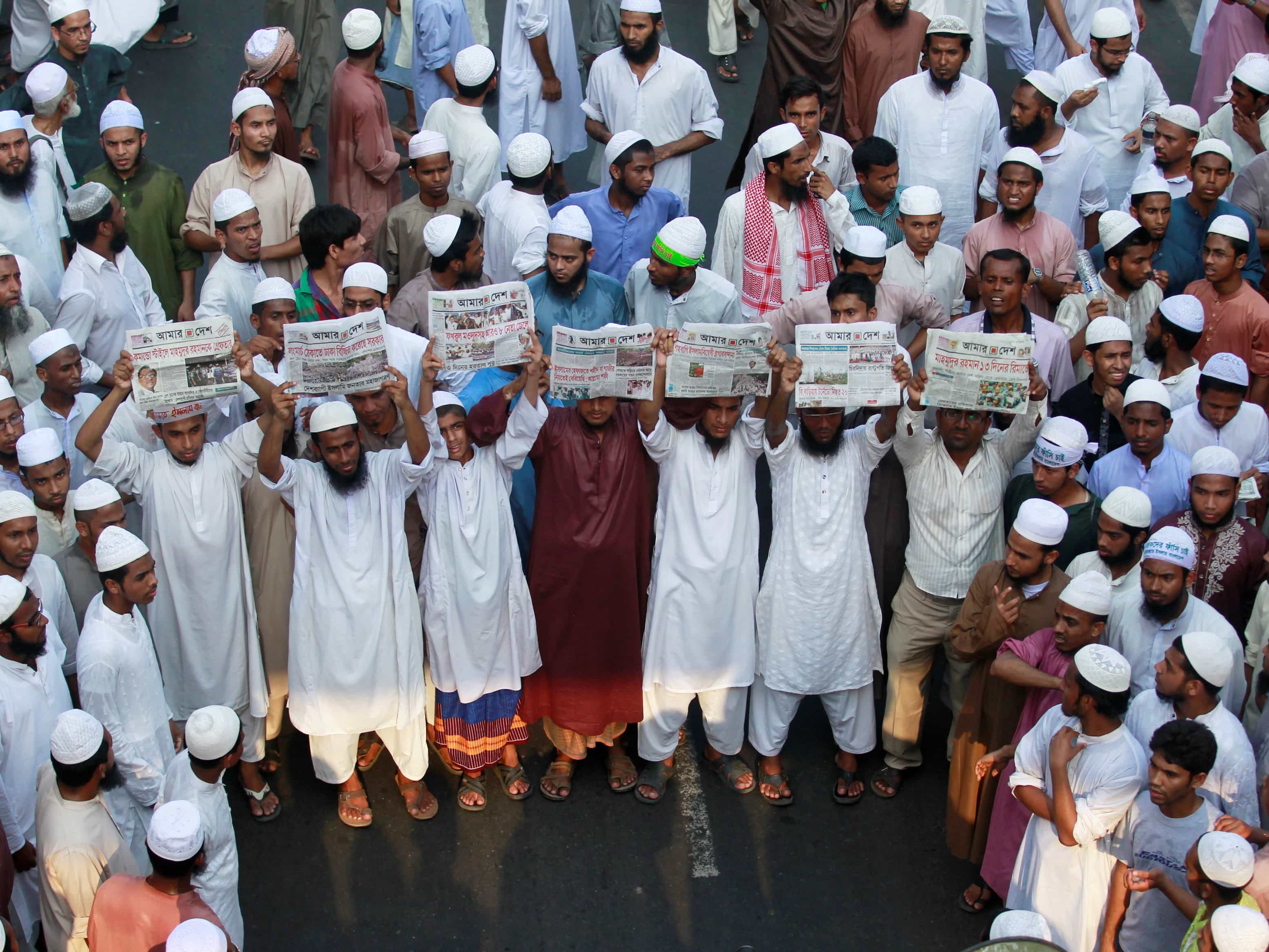 Activists of Hefajat-e-Islam hold copies of the "Amar Desh" paper during a rally in Dhaka, 12 April 2013, REUTERS/Andrew Biraj