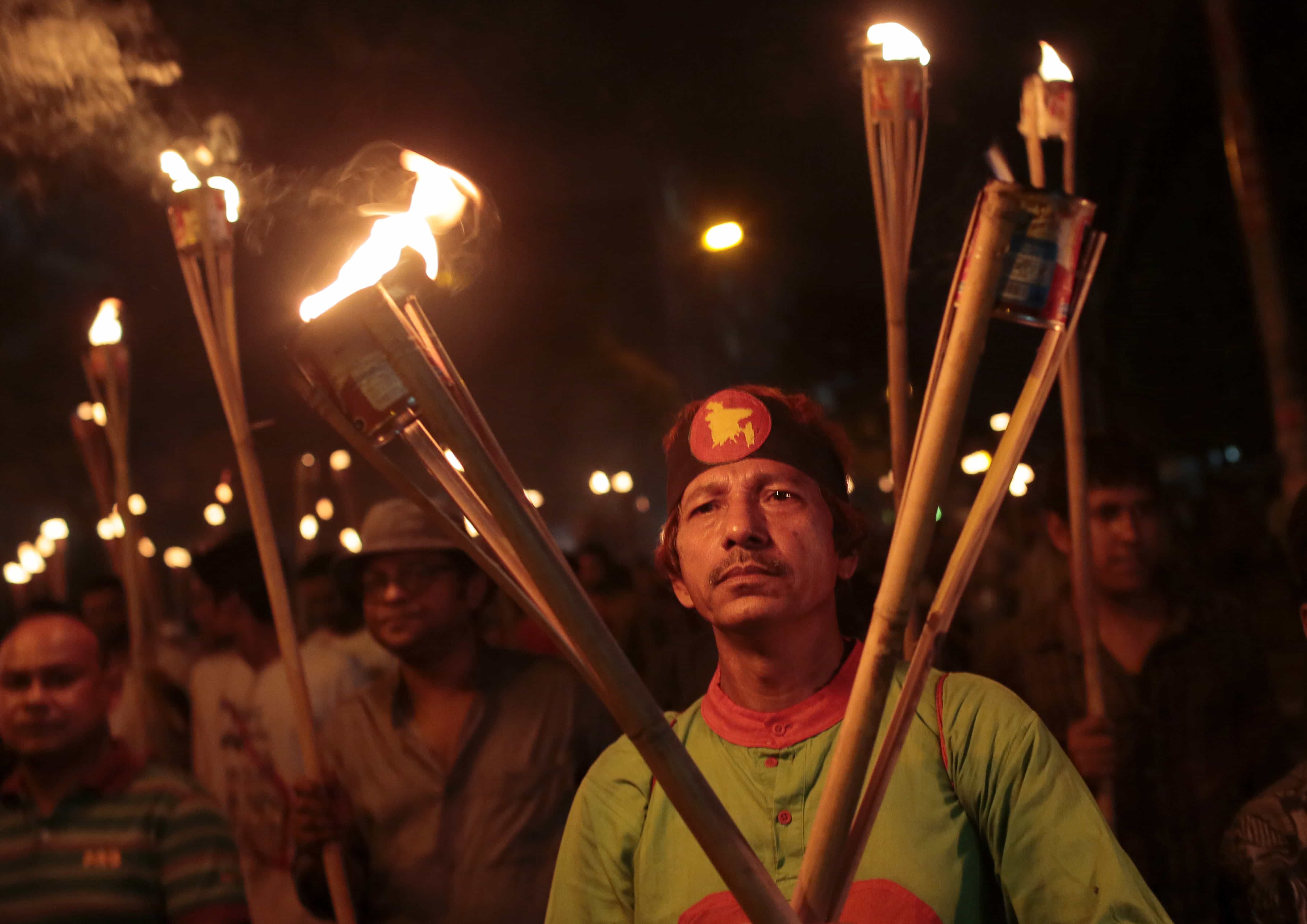 Bangladeshi activists, writers and publishers participate in a torch rally held to protest against the killing of Faisal Arefin Deepan, a publisher of secular books, and the attacks on the other publishers and bloggers in Dhaka, Bangladesh, 2 November 2015, AP Photo/ A.M. Ahad