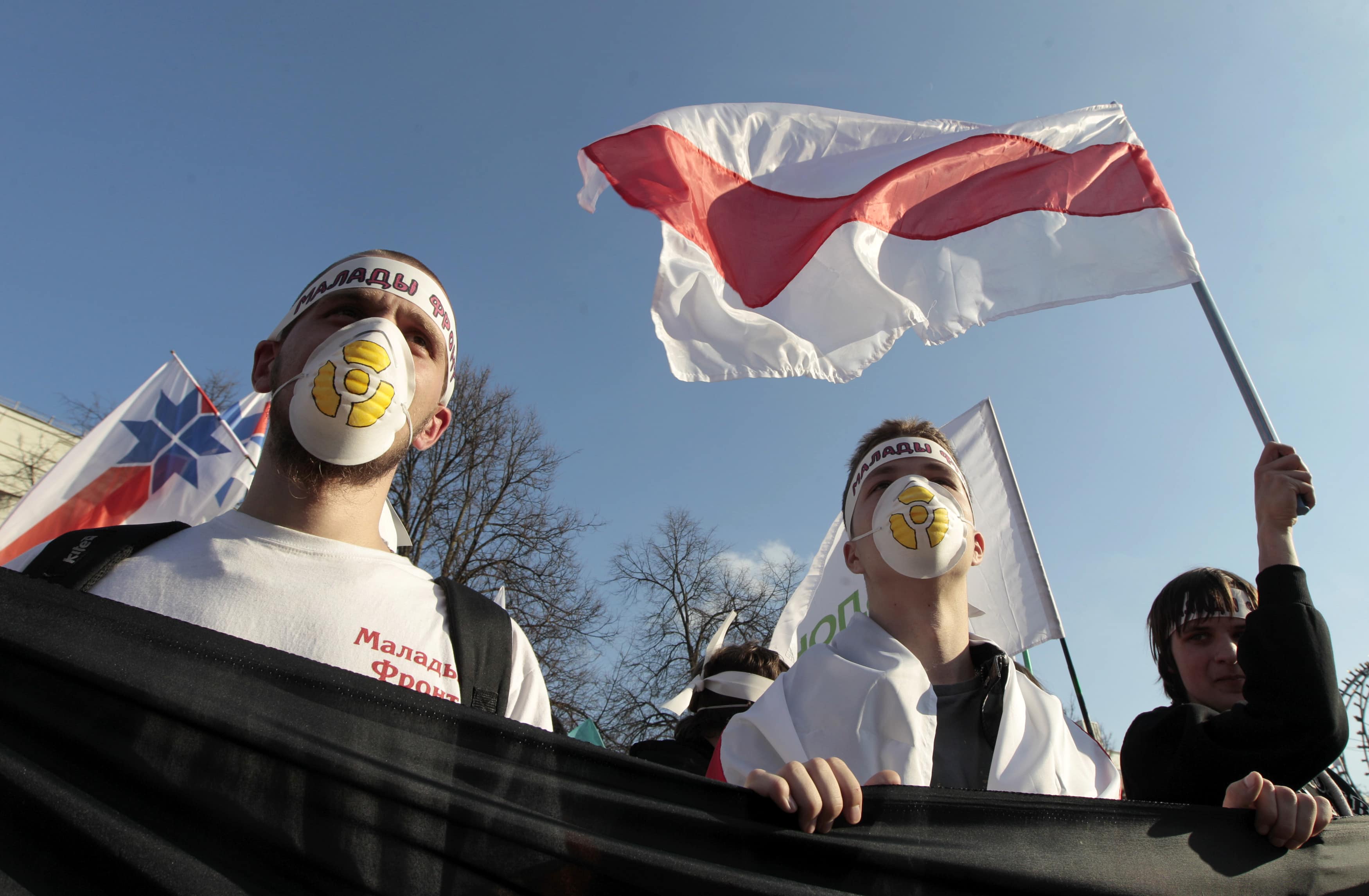 Activists hold placards and wave flags during an opposition protest to mark the Chernobyl nuclear accident in Minsk, 26 April 2012. , Vasily Fedosenko/Reuters