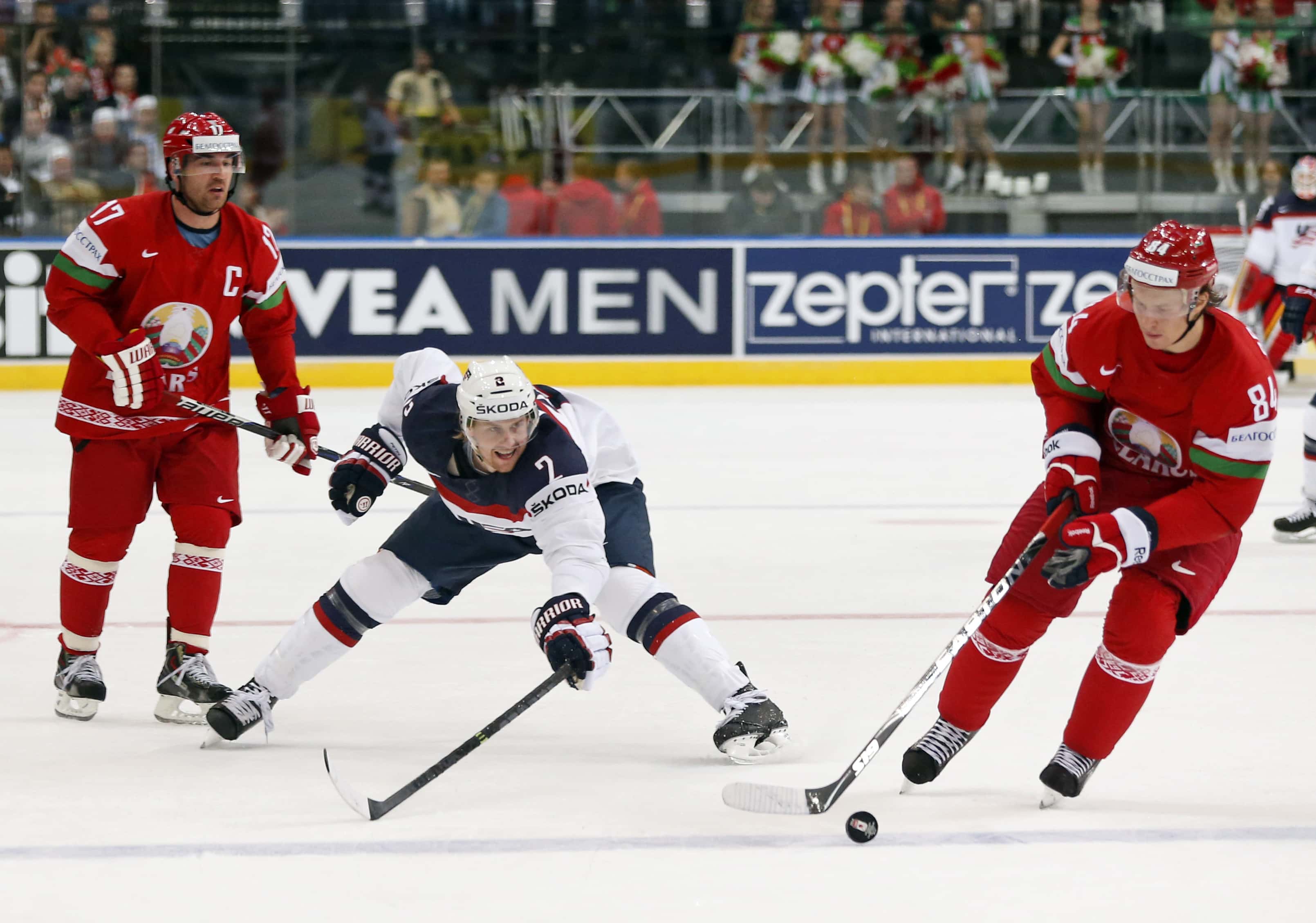 USA defender Jeff Petry, centre, is challenged by Belarus forward Alexei Kalyuzhny and Belarus forward Mikhail Grabovski, during a match between Belarus and USA at the Ice Hockey World Championship in Minsk, 9 May 2014., AP Photo/Darko Bandic