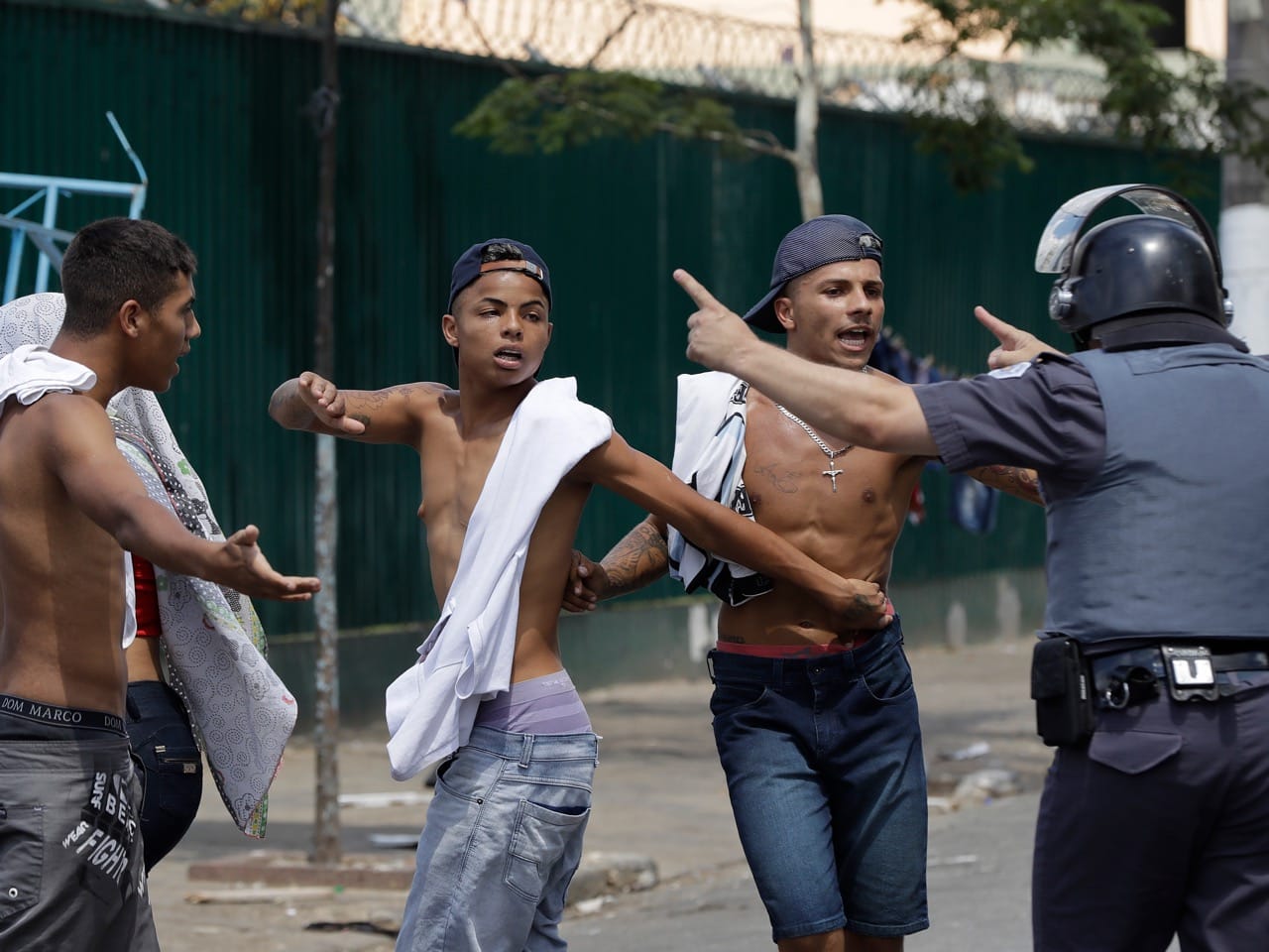 A policeman orders people to leave the street during clashes between civilians and the police, in an area popularly known as "Crackland" in downtown Sao Paulo, Brazil, 23 February 2017, AP Photo/Andre Penner