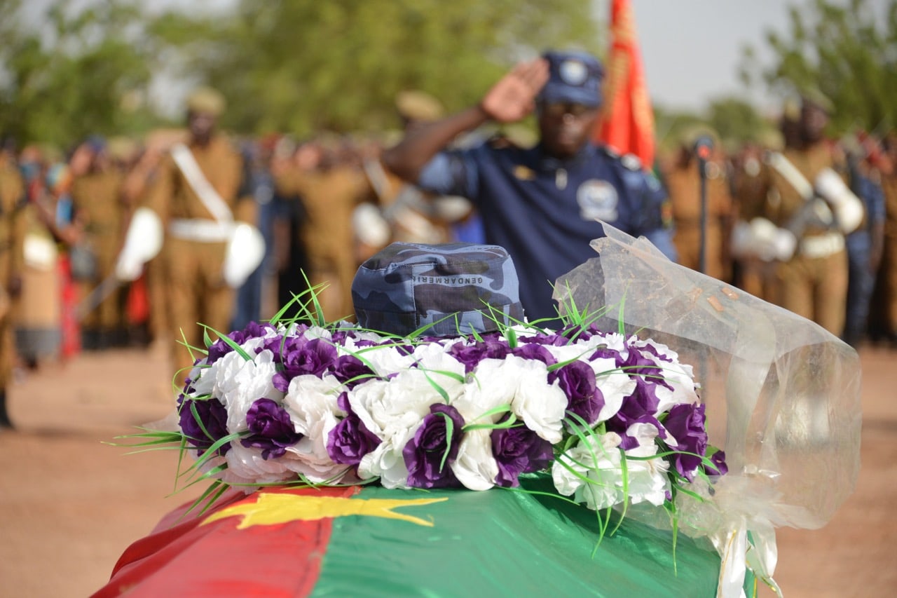 A Burkina Faso Gendarme stands guard during the funeral ceremony of his colleague, who was killed in an operation to capture suspected jihadists, in Ouagadougou, 24 May 2018, AHMED OUOBA/AFP/Getty Images