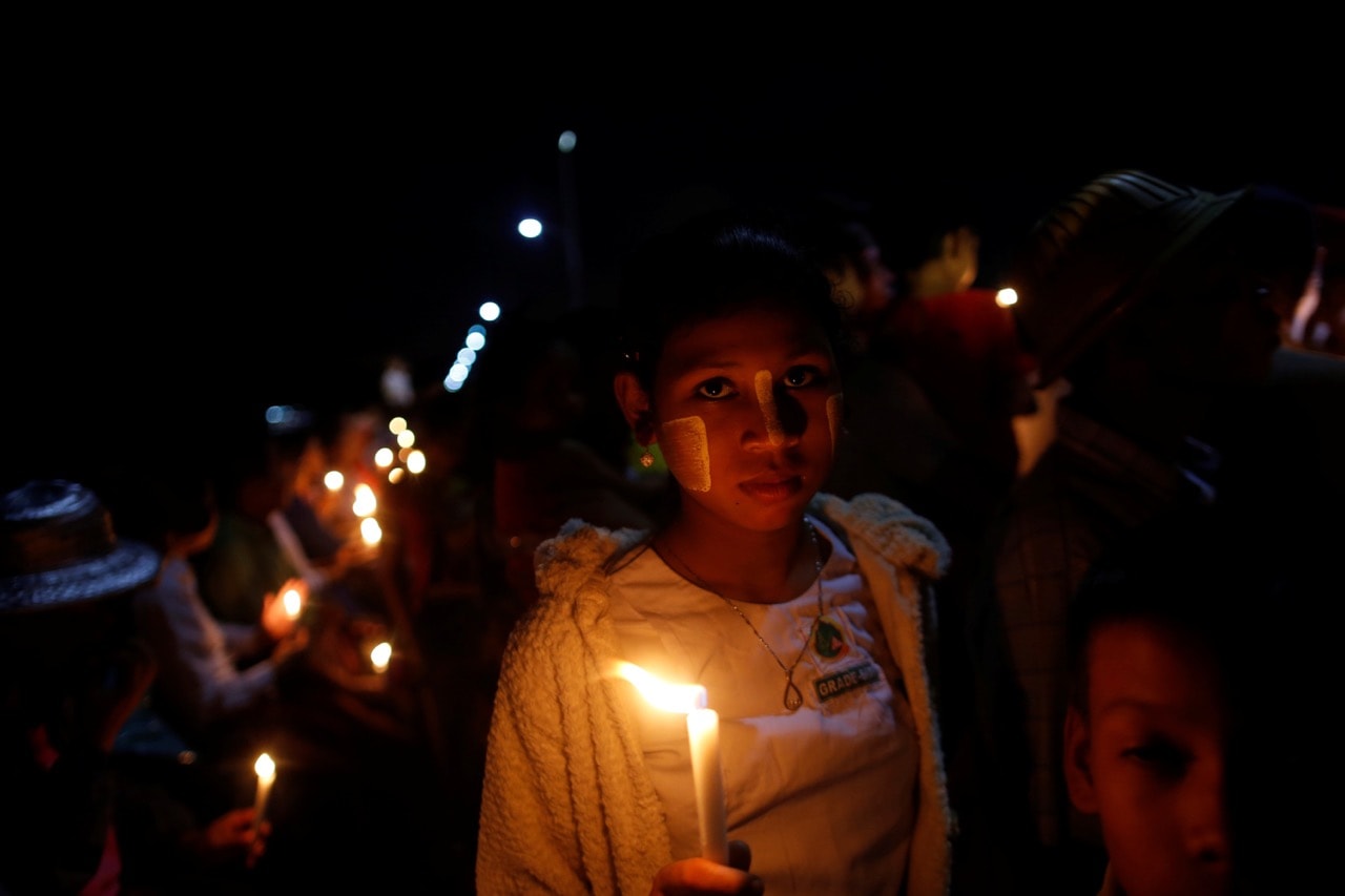 A girl holds a lit candle during a ceremony of interfaith praying in Yangon, Burma, 17 October 2017, REUTERS/Soe Zeya Tun