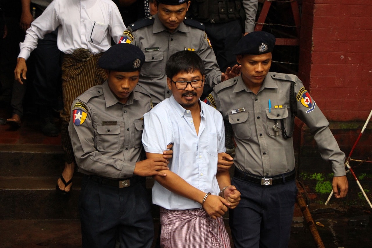 Detained journalist Wa Lone (C) is escorted by police from a courthouse following his ongoing pre-trial hearing in Yangon, Burma, 9 July 2018, MYO KYAW SOE/AFP/Getty Images