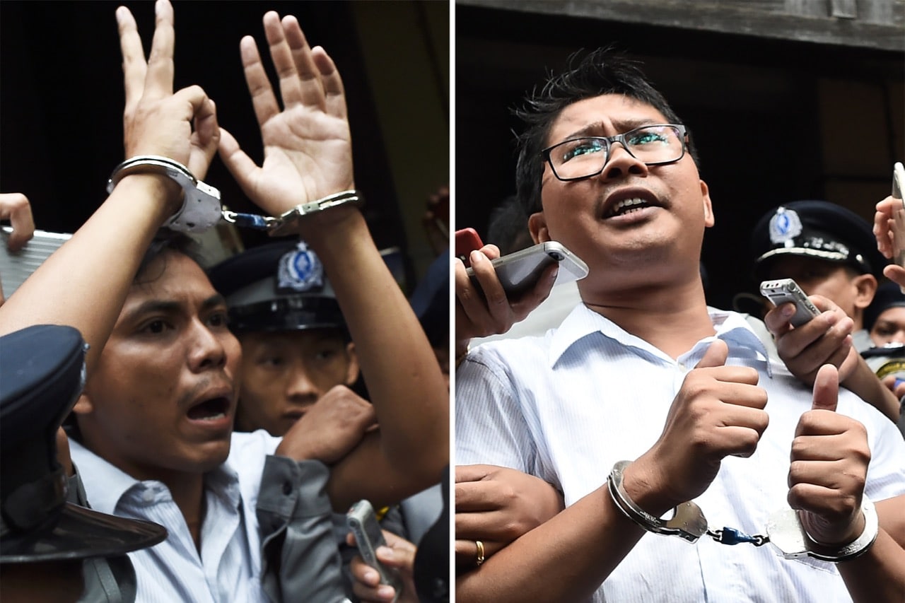 This combo shows journalists Kyaw Soe Oo (L) and Wa Lone (R) being escorted by police after their sentencing by a court to jail in Yangon, Burma, 3 September 2018, YE AUNG THU/AFP/Getty Images