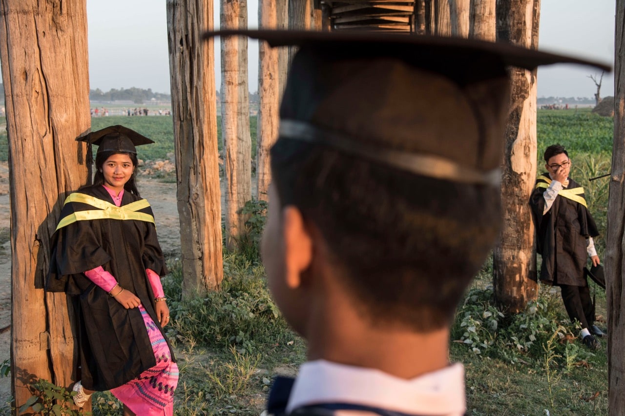 University students celebrate their recent graduation under the U Bein bridge in Amarapura, Mandalay region, Burma, 7 February 2017, Thierry Falise/LightRocket via Getty Images