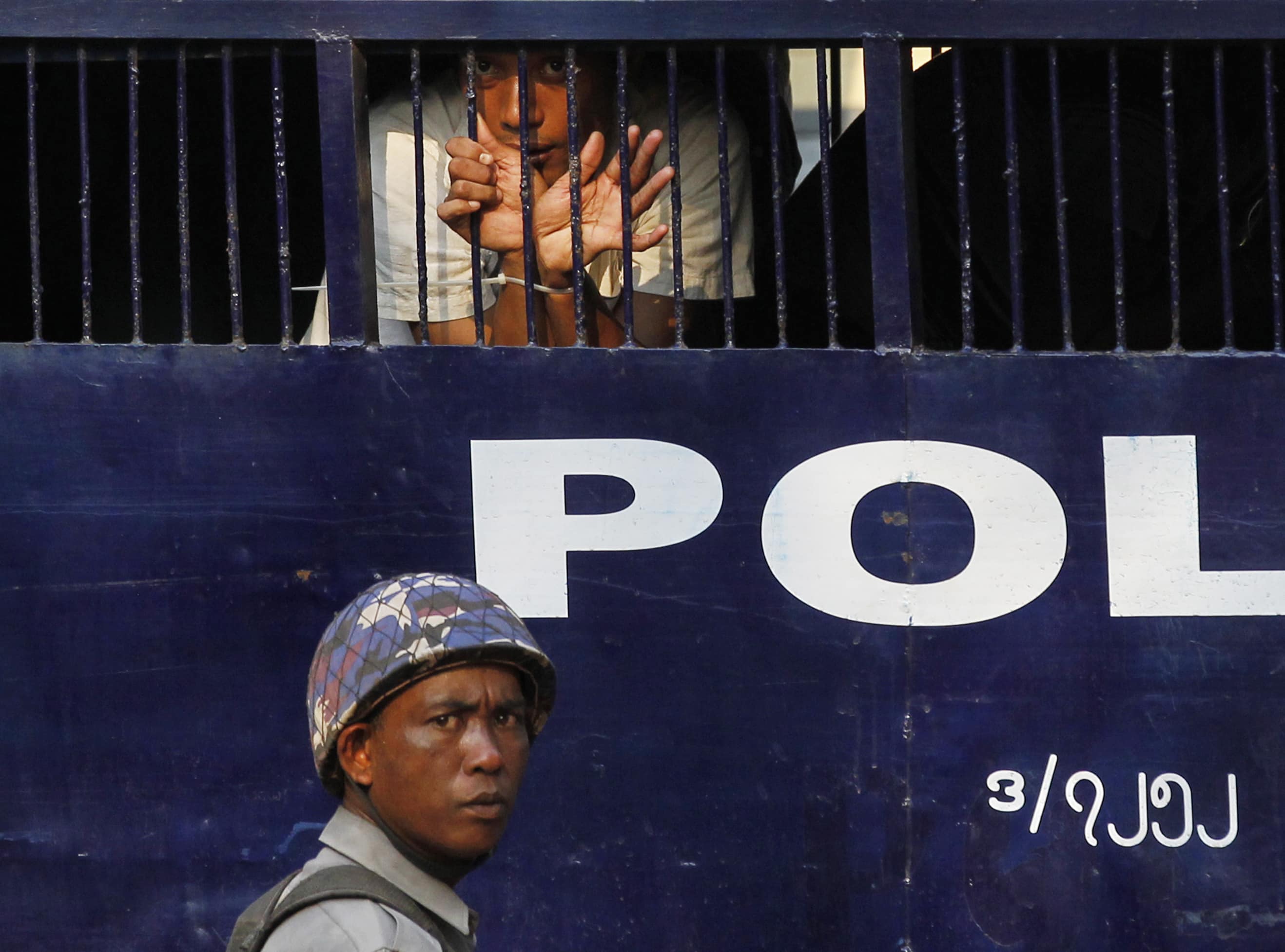 A student protester looks out from a prison vehicle as he is transported with others to a court in Letpadan, 11 March 2015, REUTERS/Soe Zeya Tun