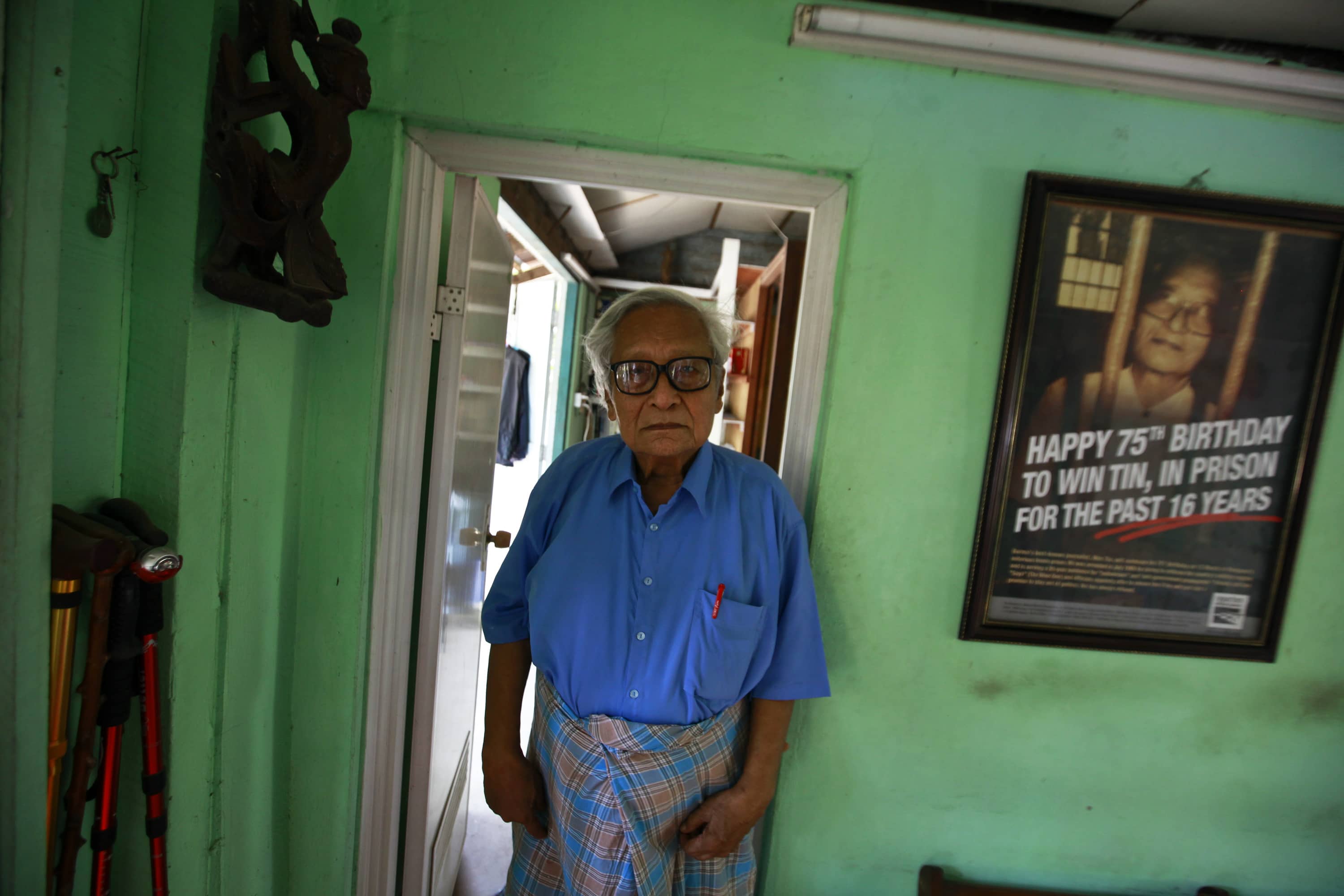 Win Tin poses in his prison issued shirt at his home in Yangon, 9 April 2013, REUTERS/Soe Zeya Tun