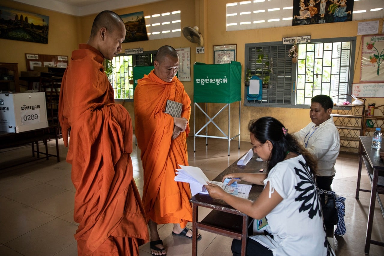 Two monks vote during the general election, in Phnom Penh, Cambodia, 29 July 2018, Paula Bronstein/Getty Images