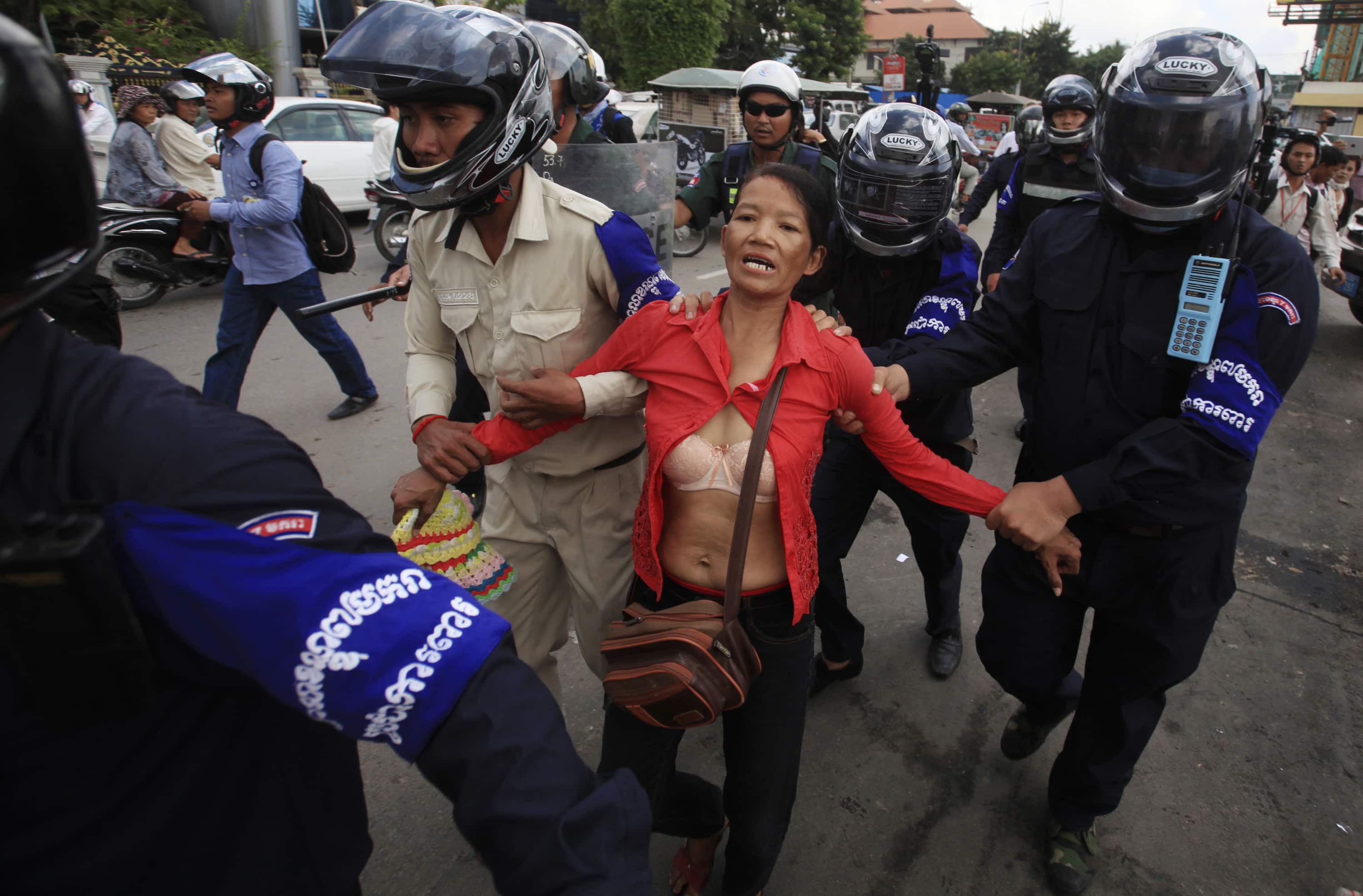 A protester is detained by police during a protest calling for the release of seven detained protesters, in front of the Phnom Penh Municipal Court, 11 November 2014, REUTERS/Samrang Pring