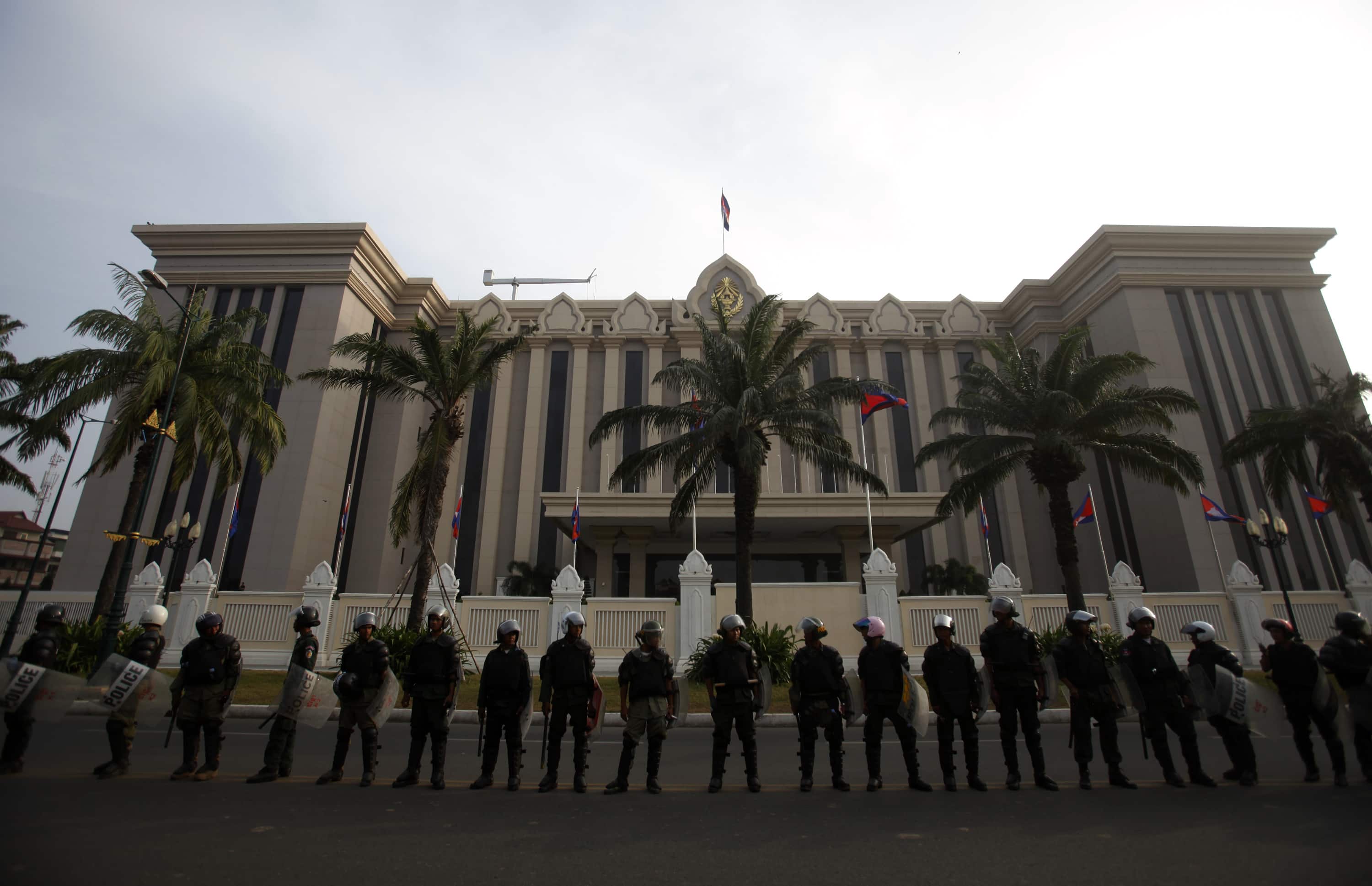 Riot police officers stand guard in front of the Council of Ministers building during a protest in Phnom Penh, in this 30 December 2013 file photo, REUTERS/Samrang Pring