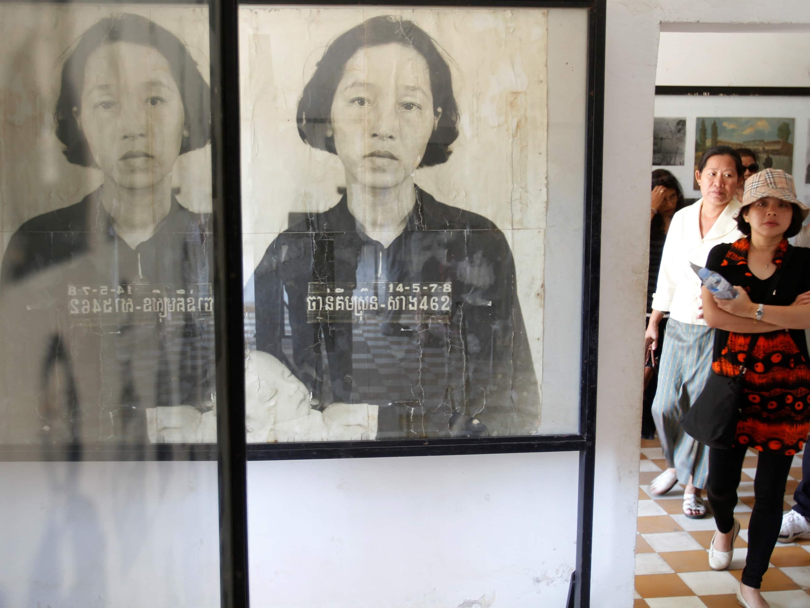 Tourists look at portraits of victims killed in the former Khmer Rouge regime's S-21 security prison, presently known as the Tuol Sleng Genocide Museum, in Phnom Penh 5 March 2013, REUTERS/Samrang Pring