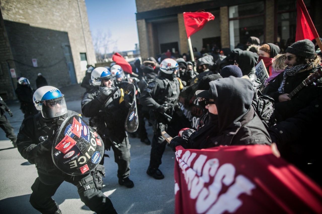 Police stand guard in front of Montreal city hall as anti-fascist groups stage a protest in Montreal, Canada, 4 March 2017, Amru Salahuddien/Anadolu Agency/Getty Images