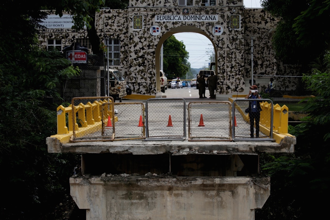 A Dominican journalist takes images with a cell phone by an old bridge at the border between Haiti and Dominican Republic that collapsed during the passage of Hurricane Irma in Ouanaminthe, Haiti, 8 September 2017, REUTERS/Andres Martinez Casares