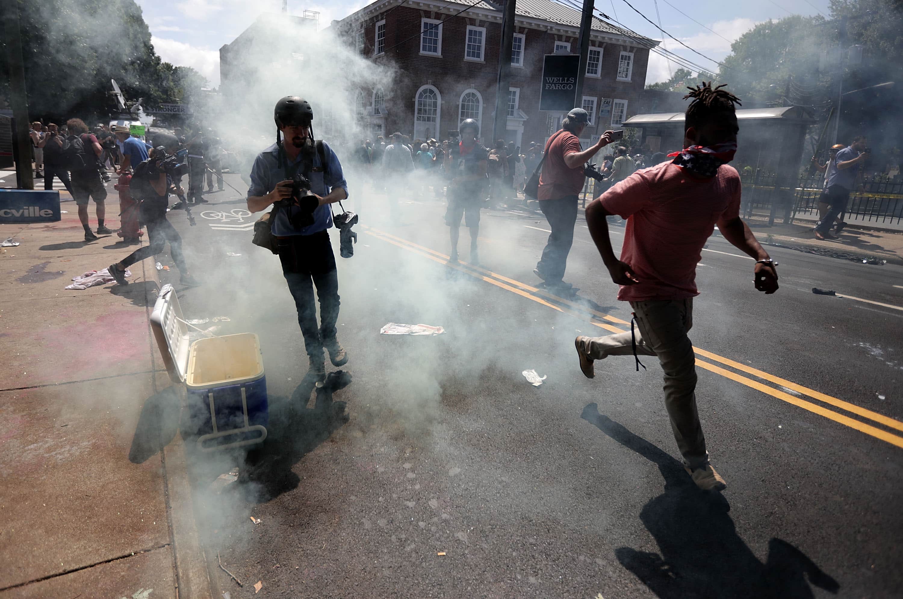 Protesters and journalists pull back after tear gas was used on the outskirts of Emancipation Park during the Unite the Right rally August 12, 2017 in Charlottesville, Virginia, Chip Somodevilla/Getty Images