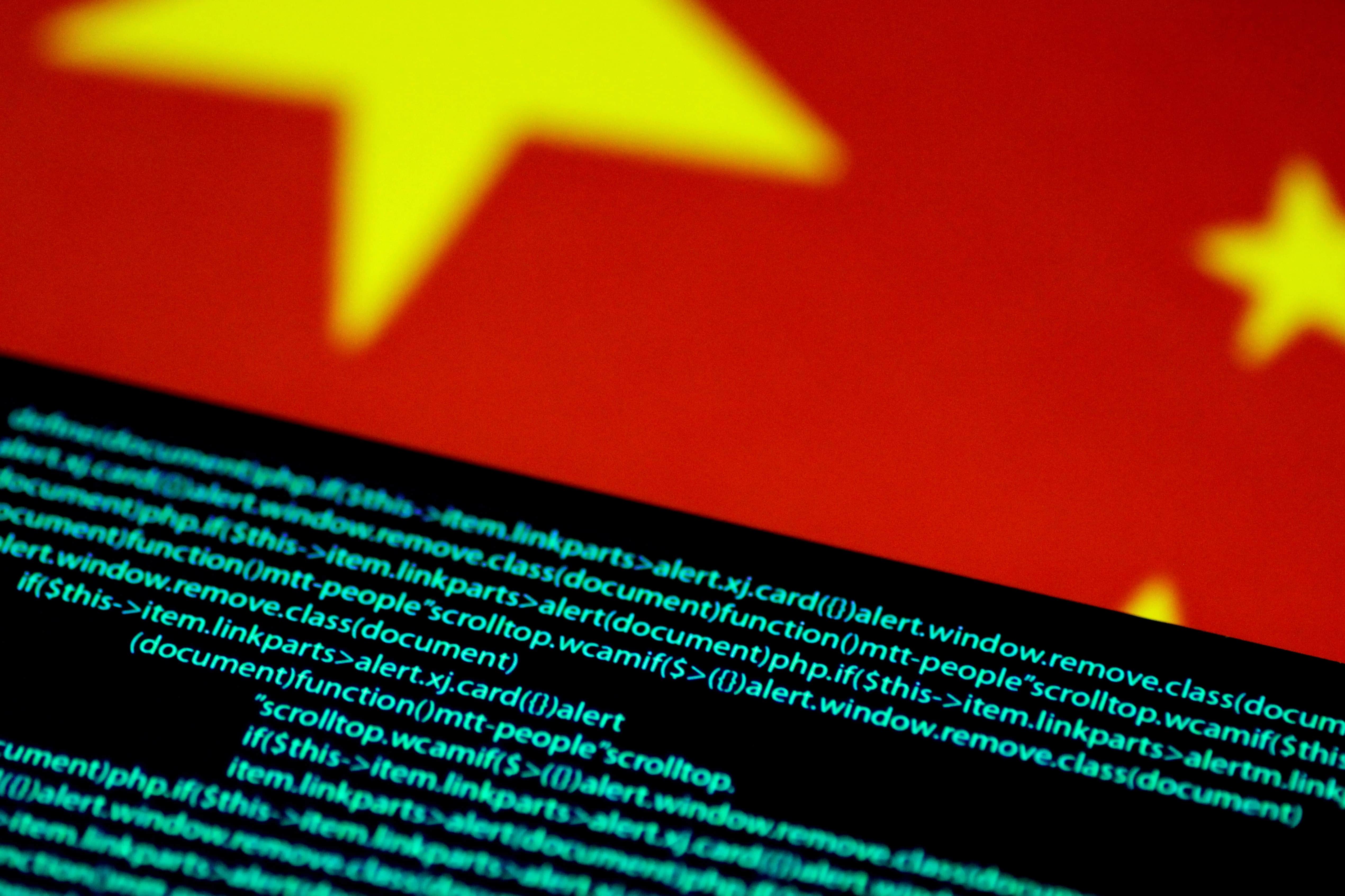 Computer code is seen on a screen above a Chinese flag in this 12 July 2017 illustration photo, REUTERS/Thomas White/Illustration