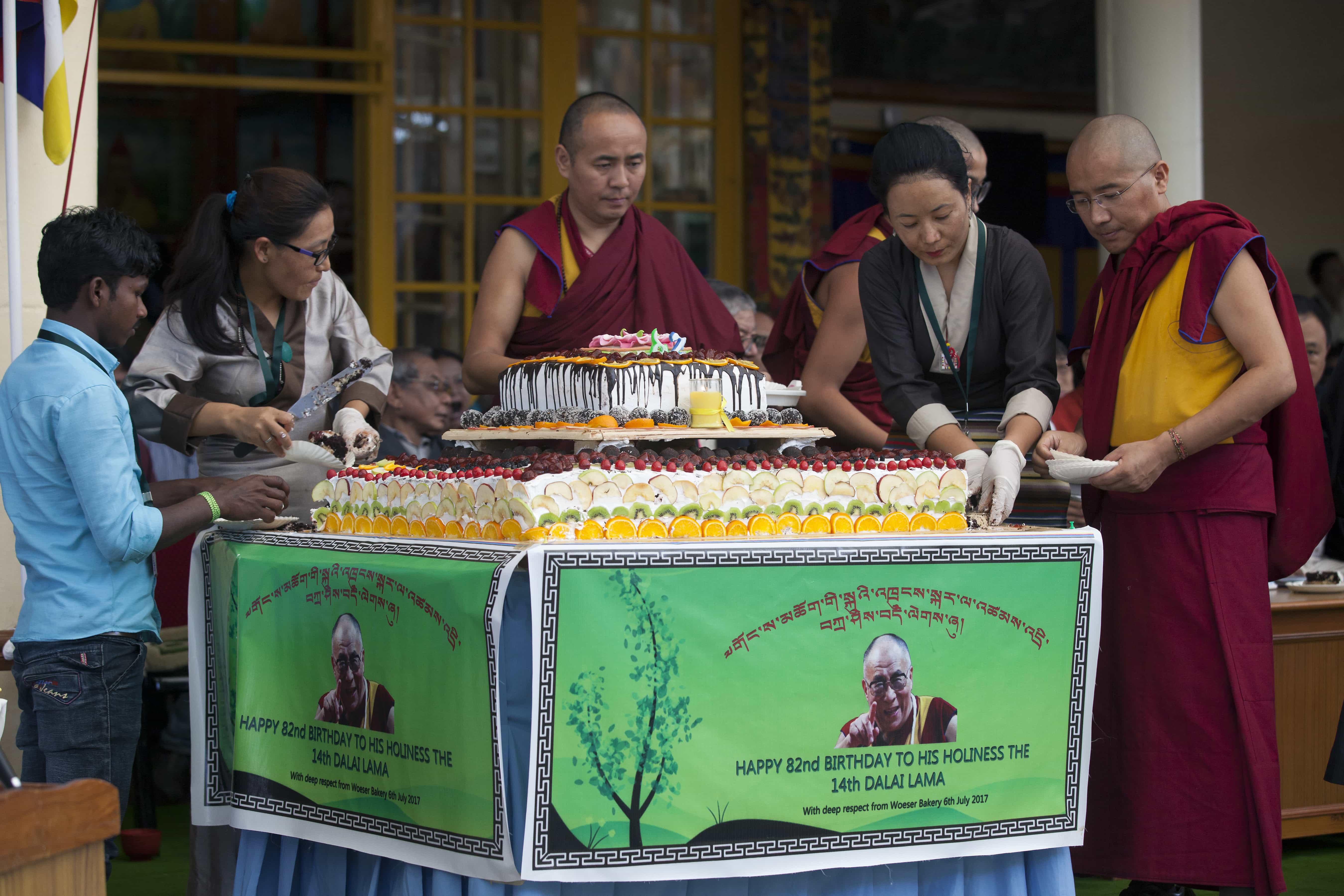 Exiled Tibetan volunteers cut a large cake to be distributed among the crowd as they mark the 82nd birthday of their spiritual leader the Dalai Lama in Dharamsala, India, 6 July 2017, AP Photo/Ashwini Bhatia