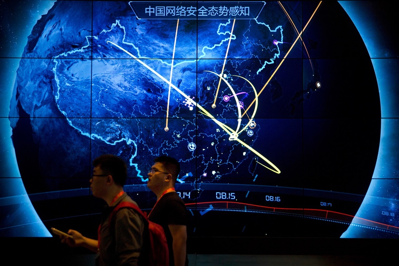 Attendees walk past an electronic display showing recent cyberattacks in China at the China Internet Security Conference in Beijing, 12 September 2017, AP Photo/Mark Schiefelbein