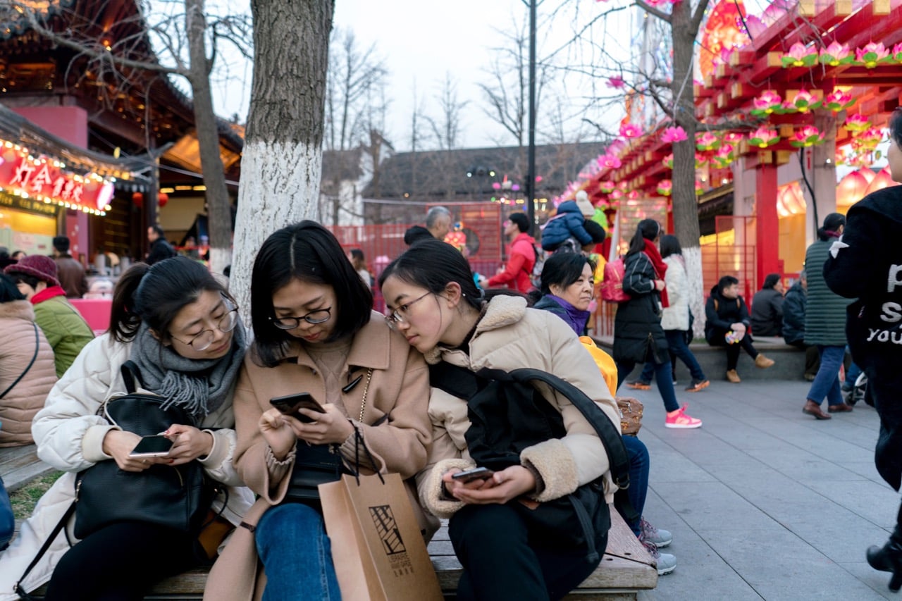 Young women look at their smartphones, in Nanjing, Jiangsu Province, China, 22 February 2018, Zhang Peng/LightRocket via Getty Images