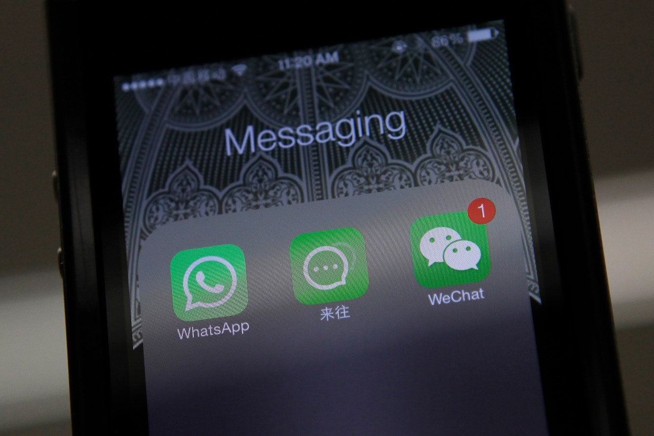 Icons of messaging applications WhatsApp of Facebook (L), Laiwang of Alibaba Group (C) and WeChat, or Weixin, of Tencent Group, are seen on the screen of a smart phone on this photo illustration taken in Beijing, 24 February 2014, REUTERS/Barry Huang