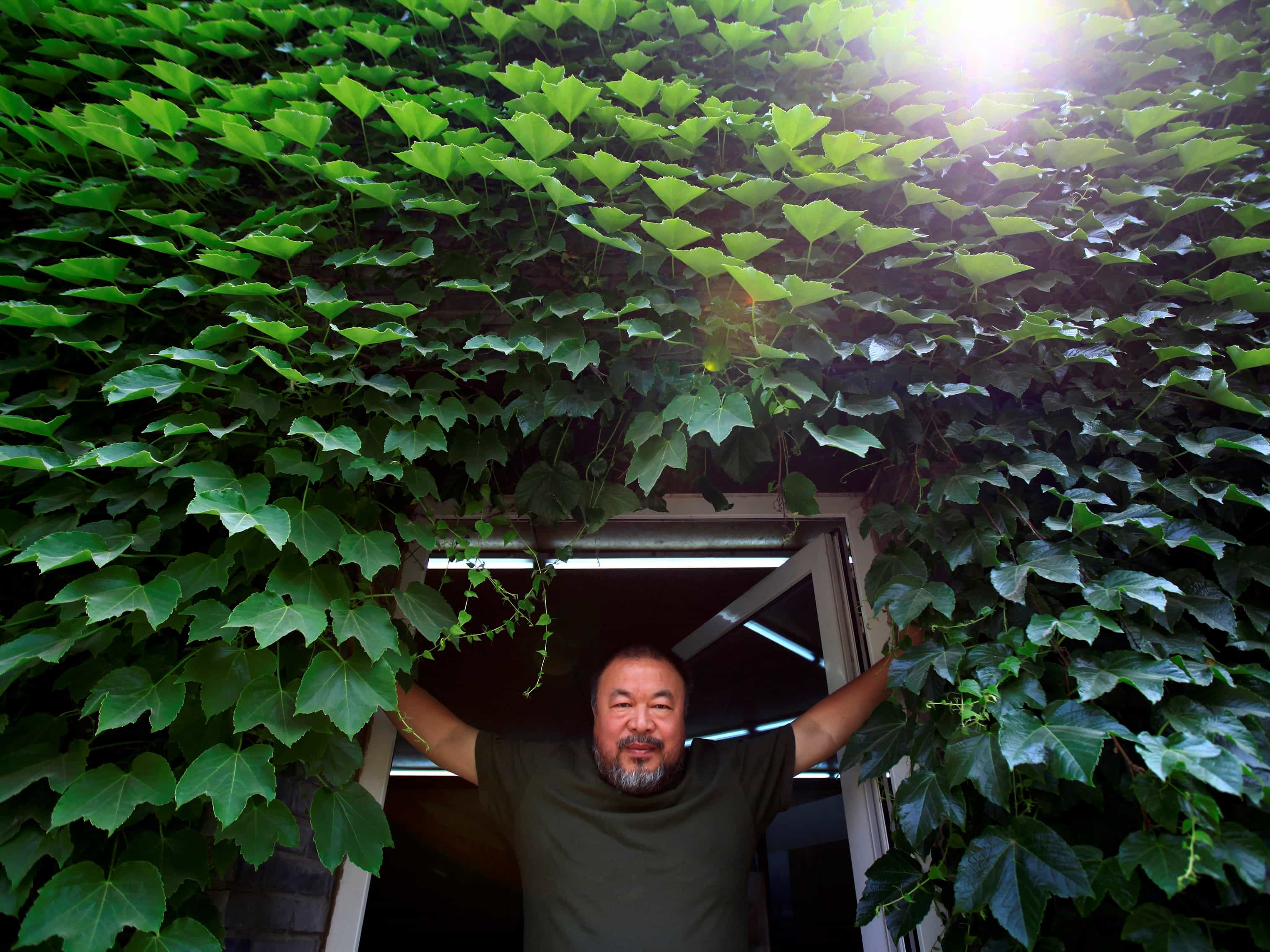 Chinese artist Ai Weiwei at the door to his studio in Beijing, 22 May 2013. Ai made his first foray into the musical world with the release of the song "Dumbass" that takes inspiration from his detention in 2011, REUTERS/Petar Kujundzic