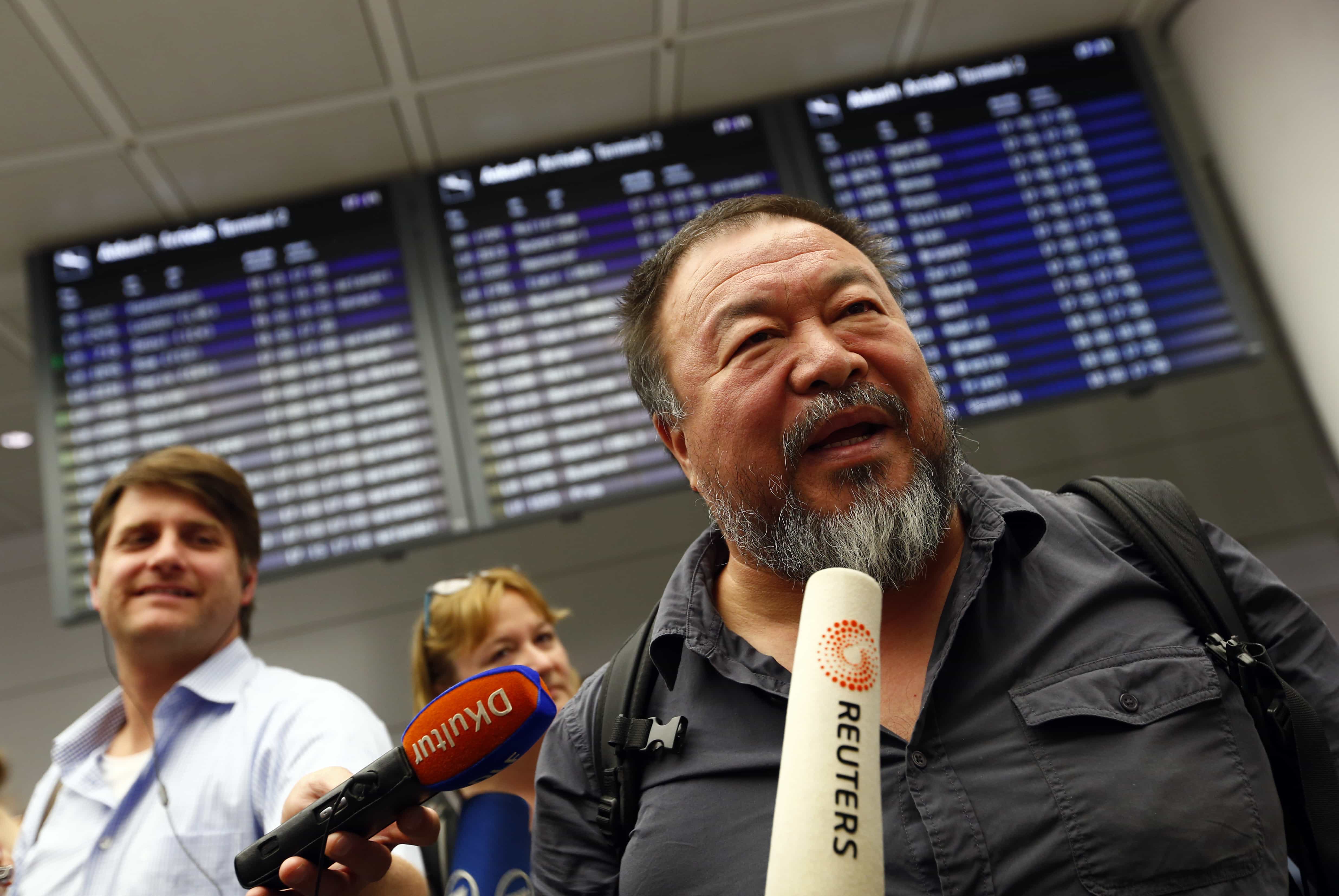 Dissident Chinese artist Ai Weiwei talks with media as he arrives at the airport in Munich, Germany, 30 July 2015, REUTERS/Michaela Rehle