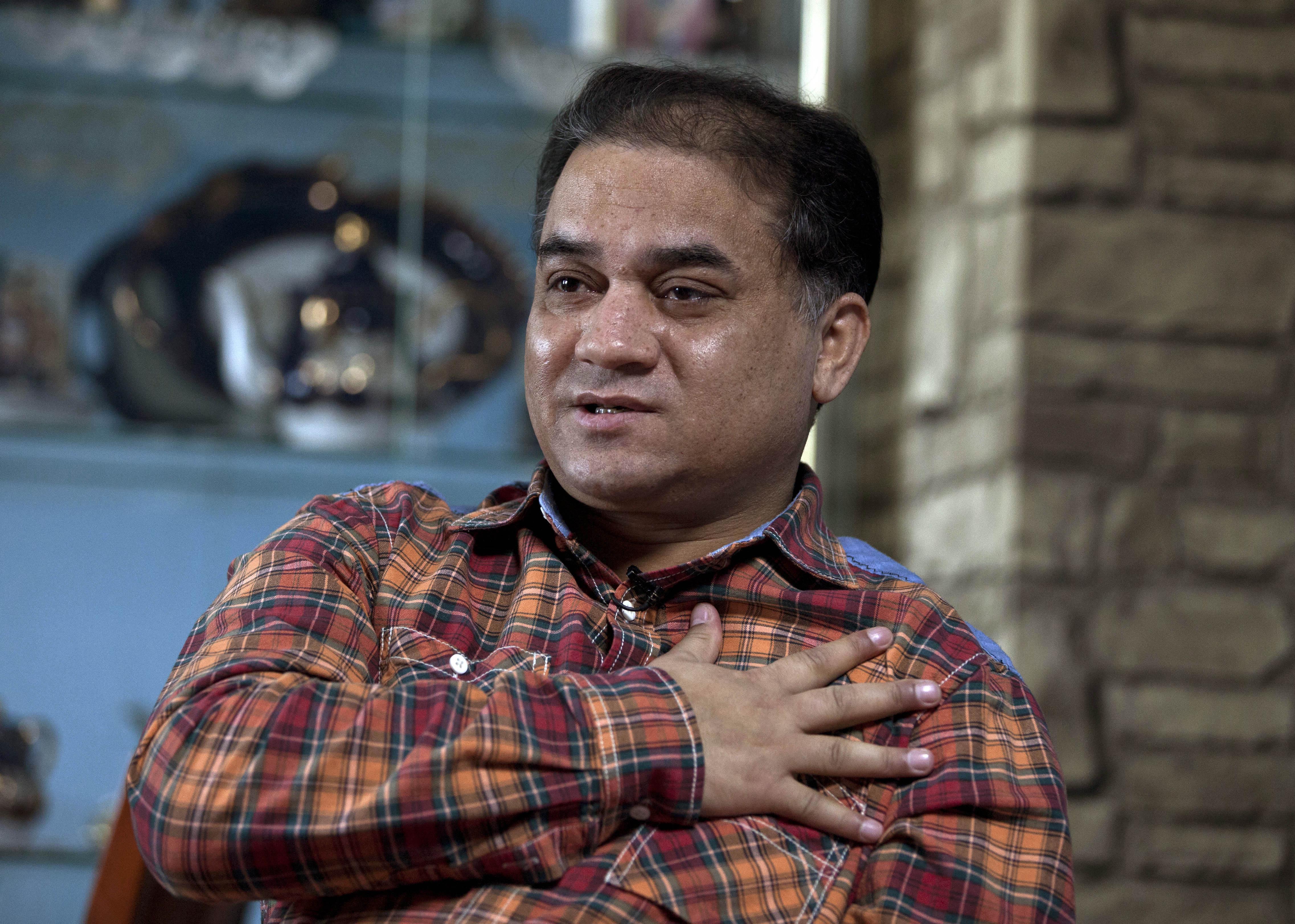 In this 4 February 2013 file photo, Ilham Tohti speaks during an interview at his home in Beijing, China, AP Photo/Andy Wong, File