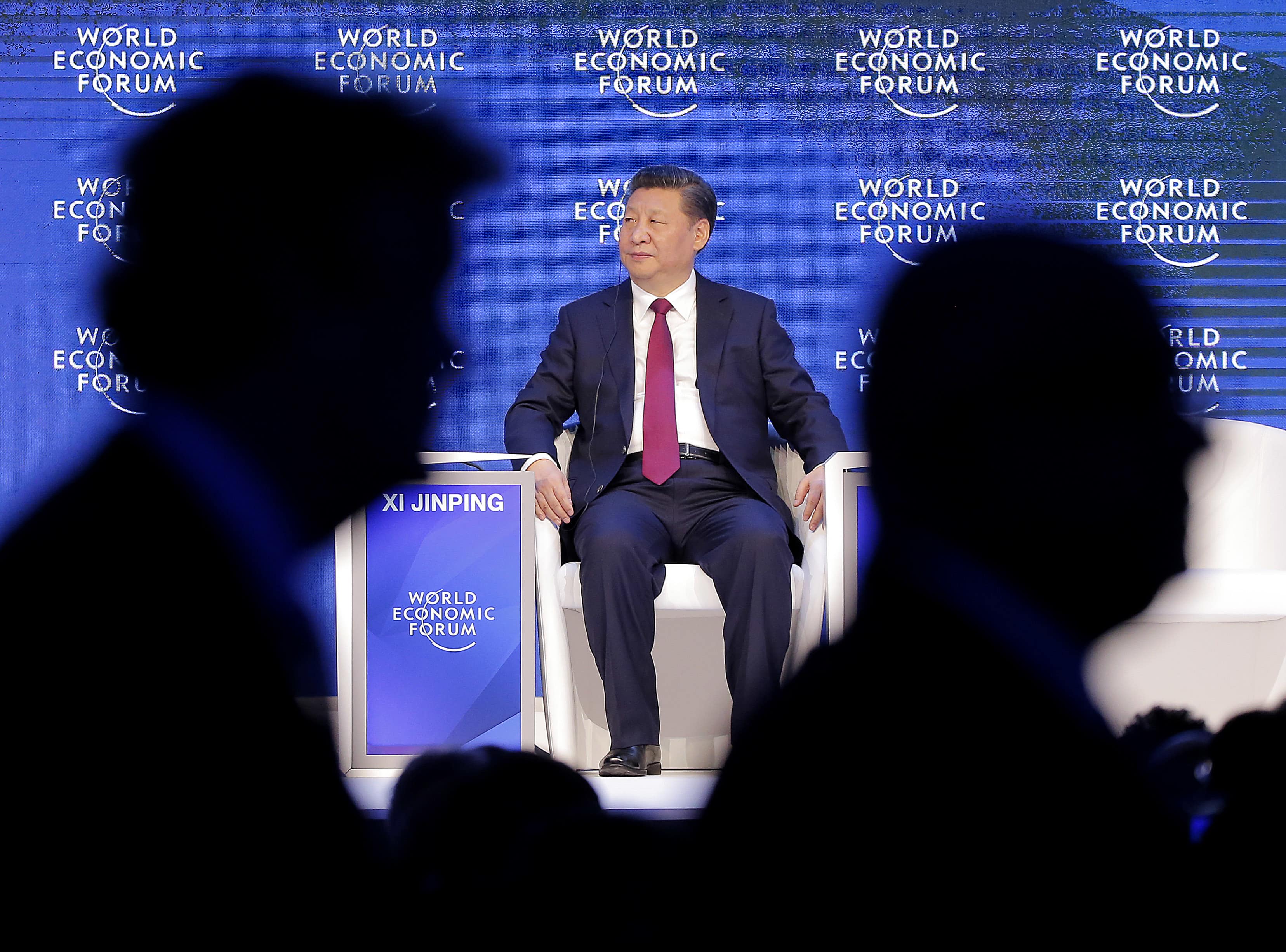 China's President Xi Jinping sits on the podium while people leave at the World Economic Forum in Davos, Switzerland, 17 January 2017, AP Photo/Michel Euler