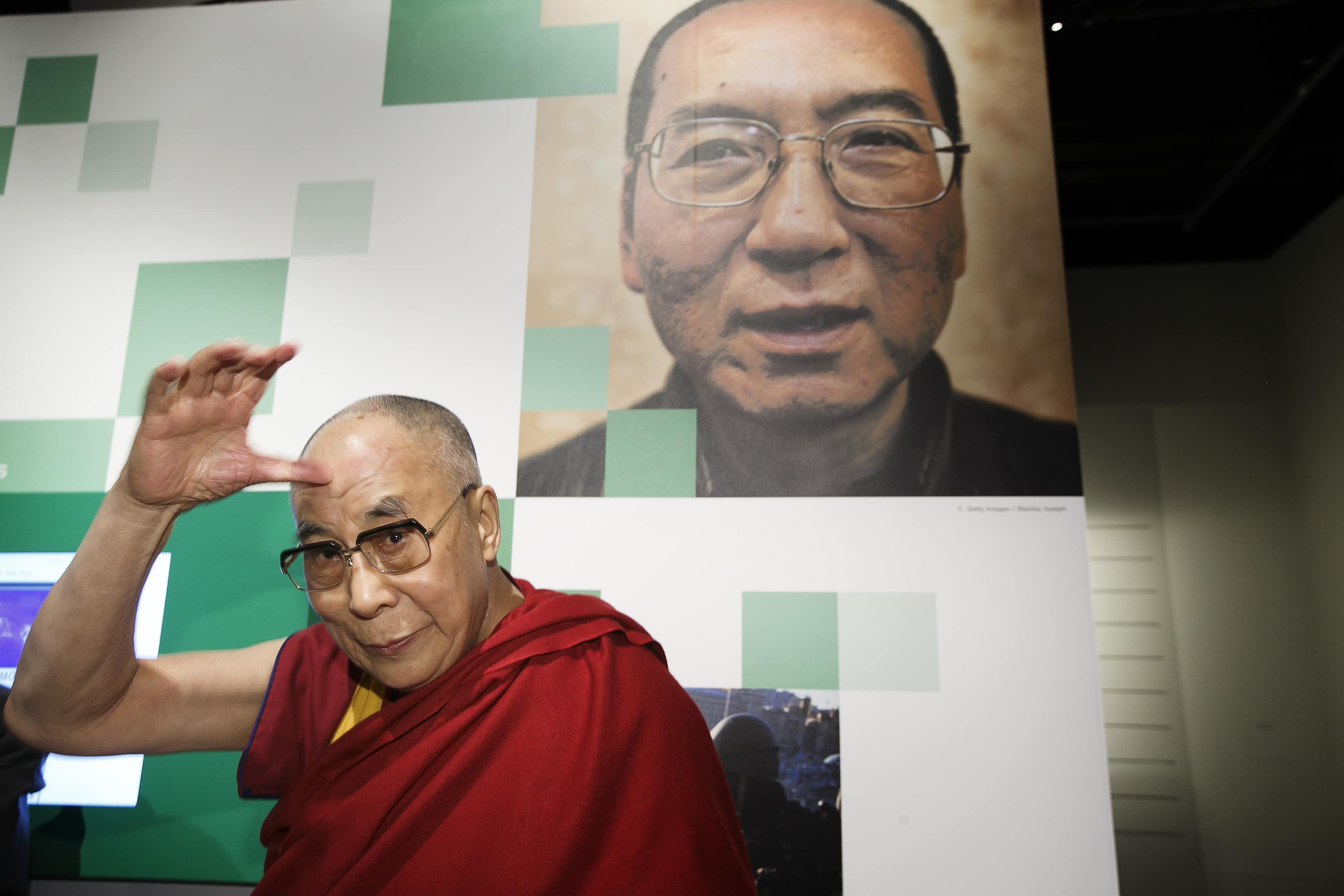 The Dalai Lama is seen during a visit to the Nobel Peace Center in Oslo, 9 May 2014. On the wall is a portrait of 2010 Nobel Peace Prize winner Liu Xiaobo, REUTERS/Heiko Junge/NTB Scanpix