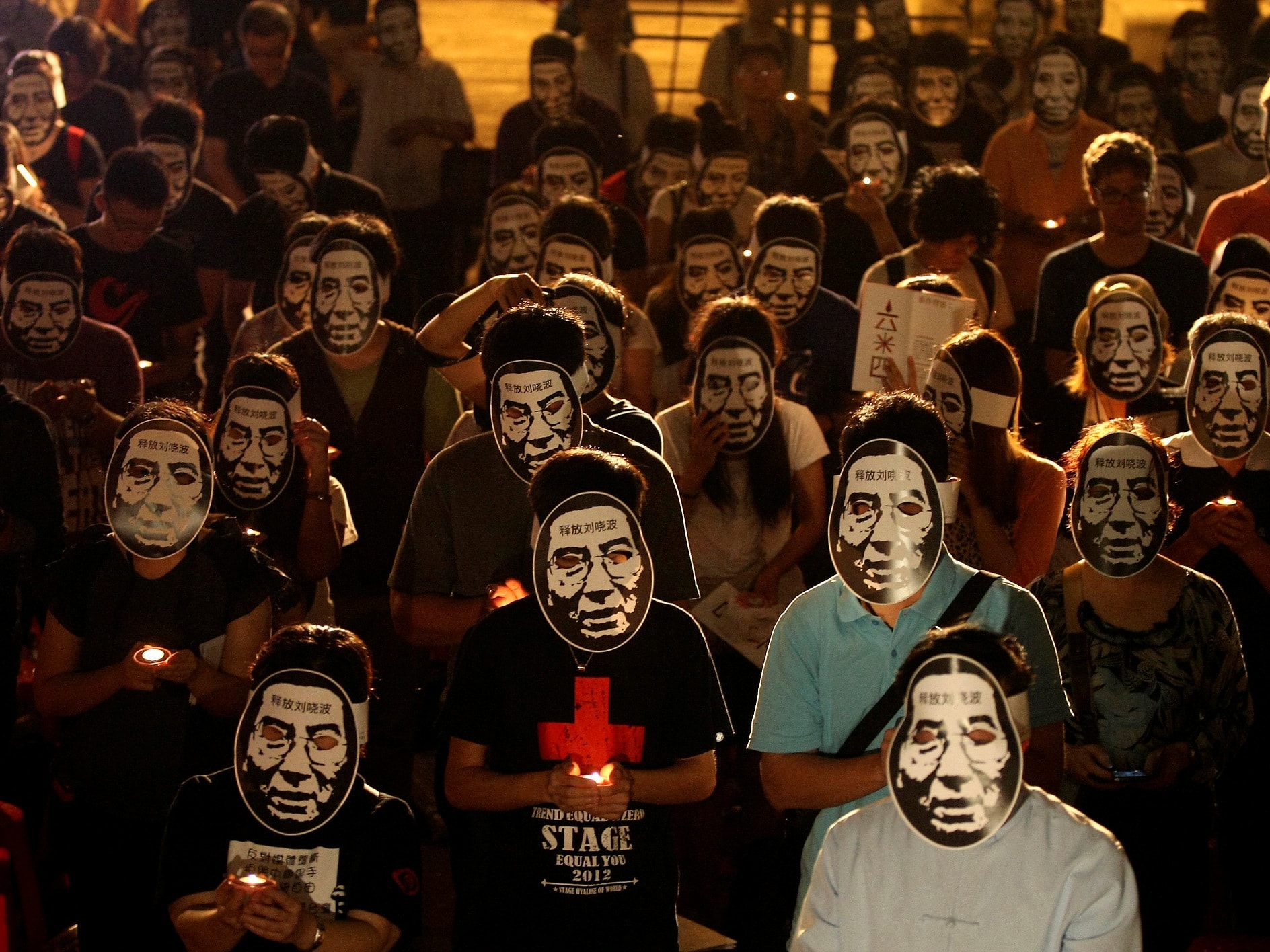 Activists wearing masks of China's jailed Nobel laureate Liu Xiaobo at a night vigil in Taipei, Taiwan on 4 June 2013, the anniversary of the Tiananmen Square massacre, REUTERS/Steven Chen