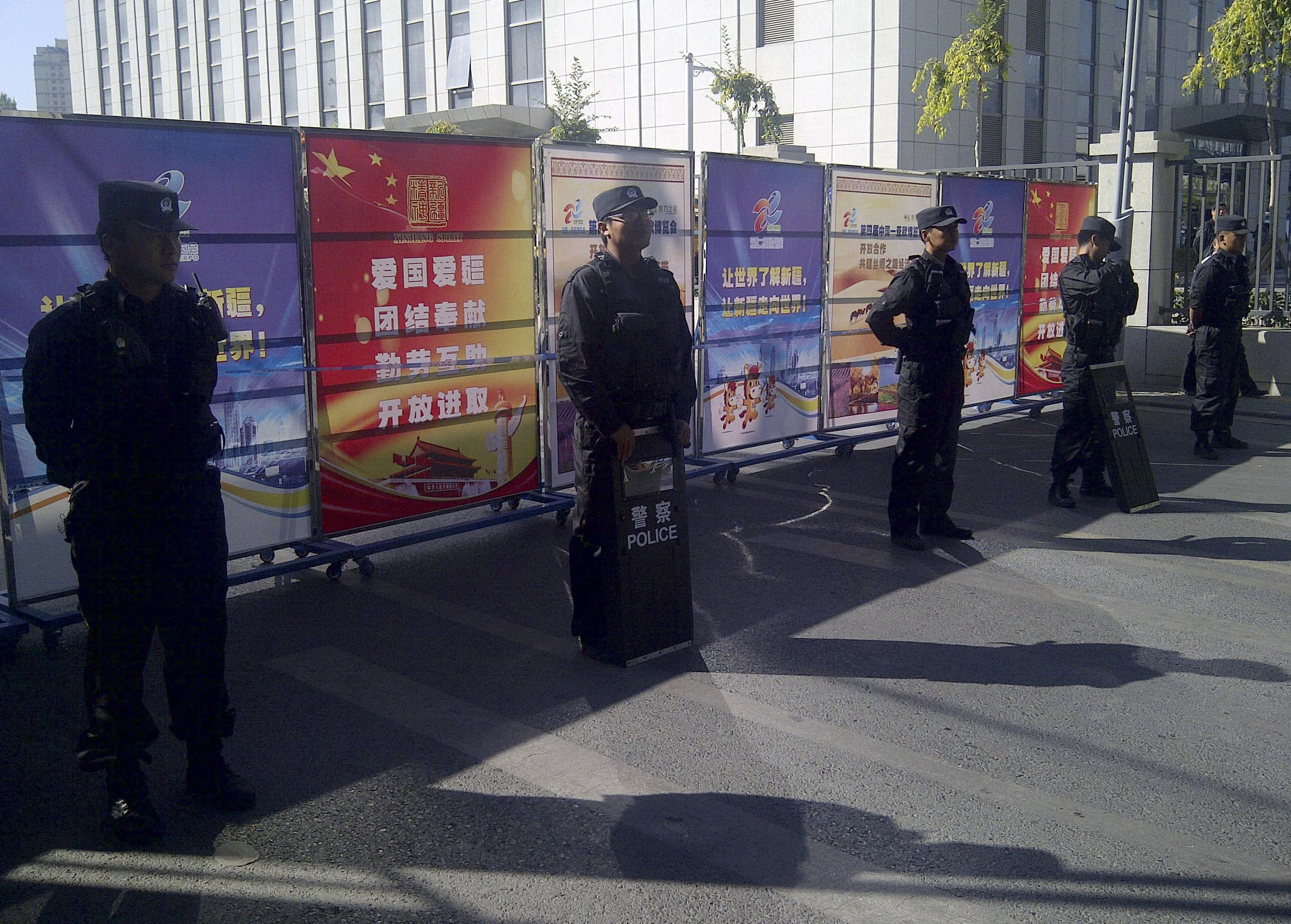 Policemen in riot gear guard a checkpoint on a road near a courthouse where Tohti's trial was taking place in Urumqi, Xinjiang Uighur Autonomous Region, 17 September 2014, Reuters/Stringer