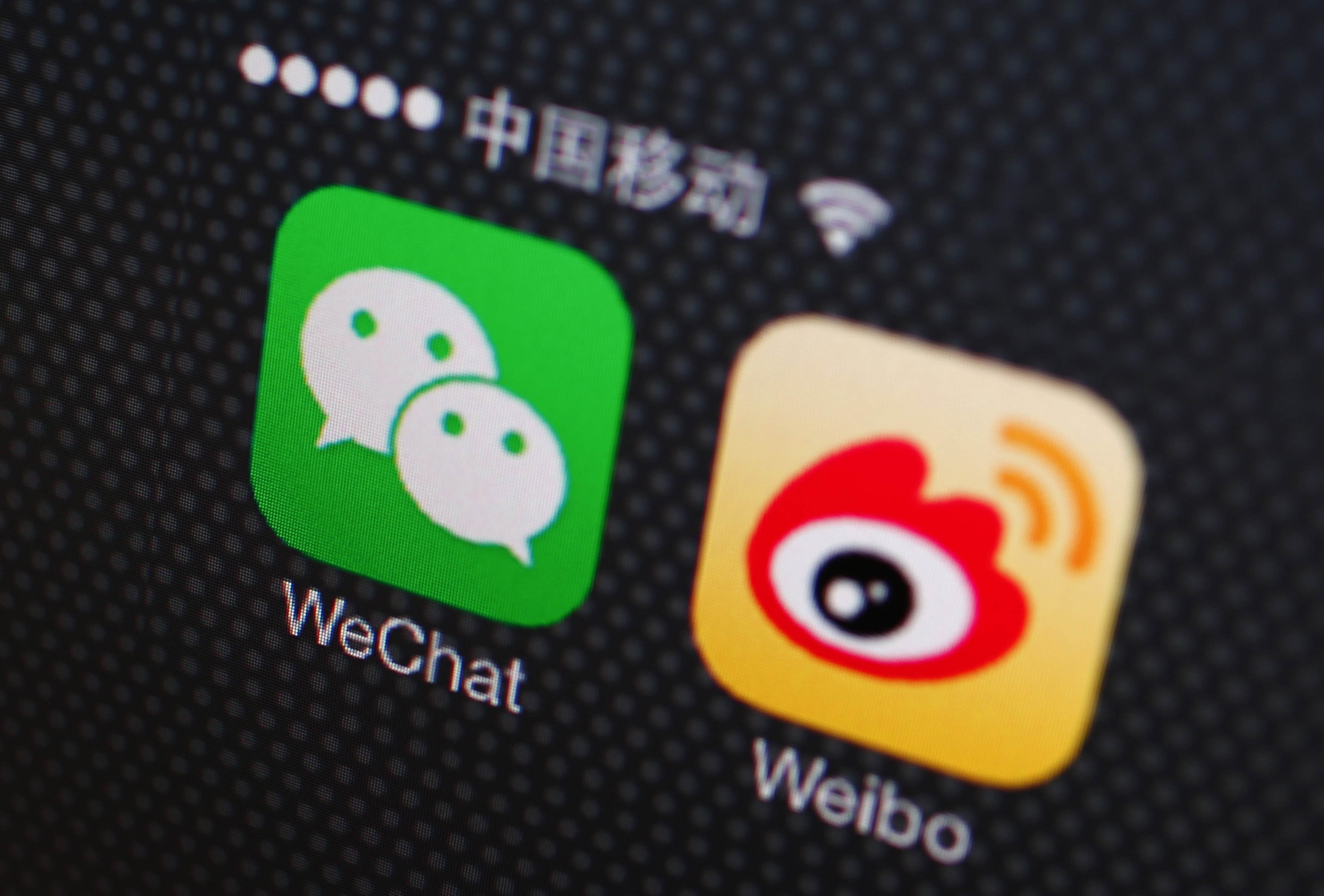 A picture illustration shows icons of WeChat and Weibo app in Beijing, 5 December 2013, REUTERS/Petar Kujundzic