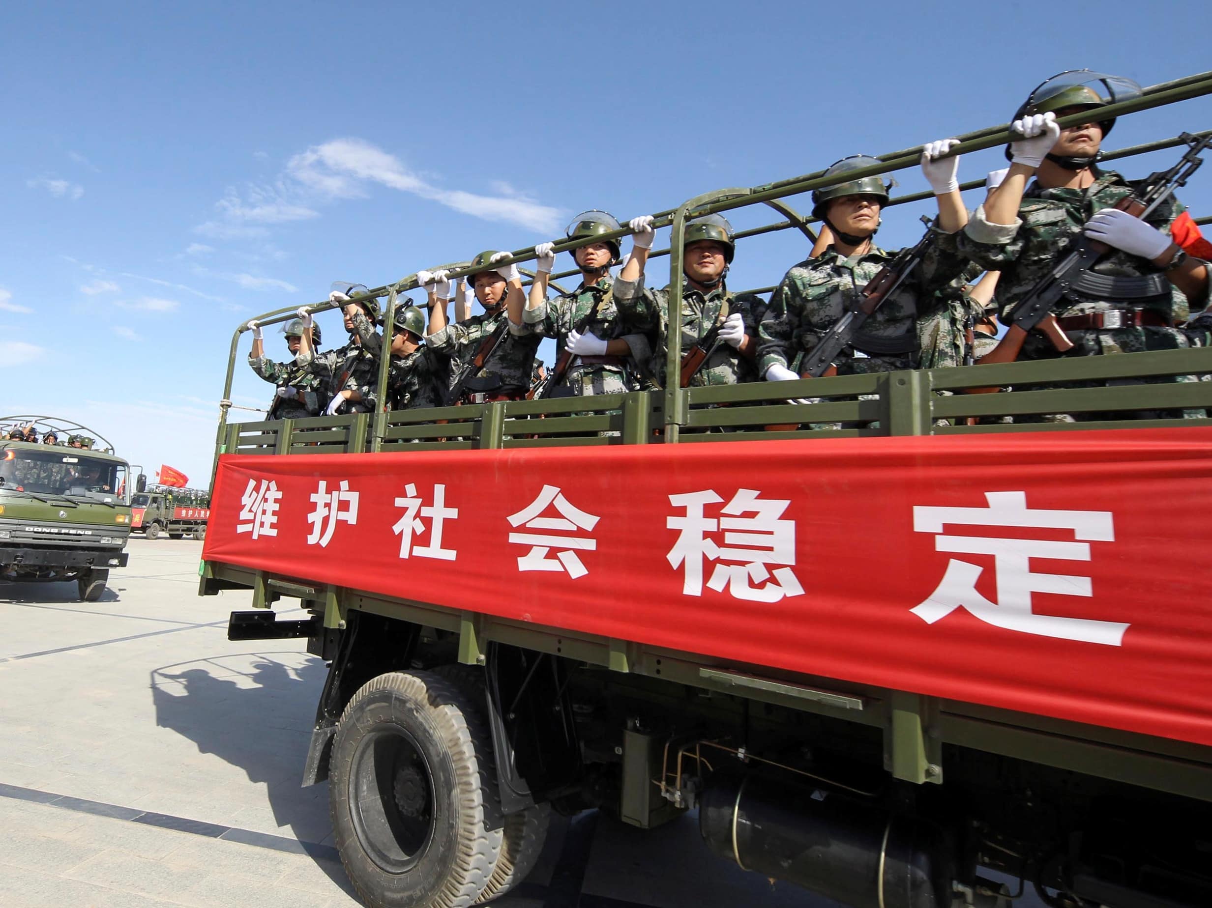 Armed members from a Chinese militia take part in an anti-terrorism joint exercise in Hami, Uighur Autonomous Region, 2 July 2013; the Chinese characters on the vehicle read, "Maintain social stability", REUTERS/Stringer
