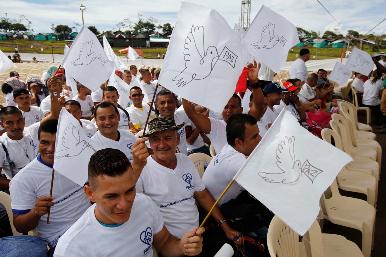 In this 27 June 2017 file photo, rebels of the Revolutionary Armed Forces of Colombia, FARC, wave white peace flags during an act to commemorate the completion of their disarmament process in Buenavista, Colombia, AP Photo/Fernando Vergara, File