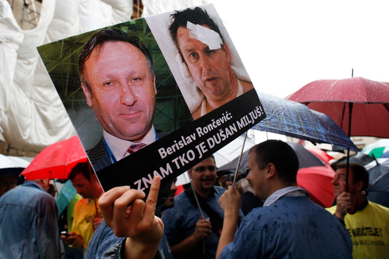 Photographs of Interior Minister Berislav Roncevic (L) and journalist Dusan Miljus are displayed during a protest in Zagreb, 6 June 2008, REUTERS/Nikola Solic