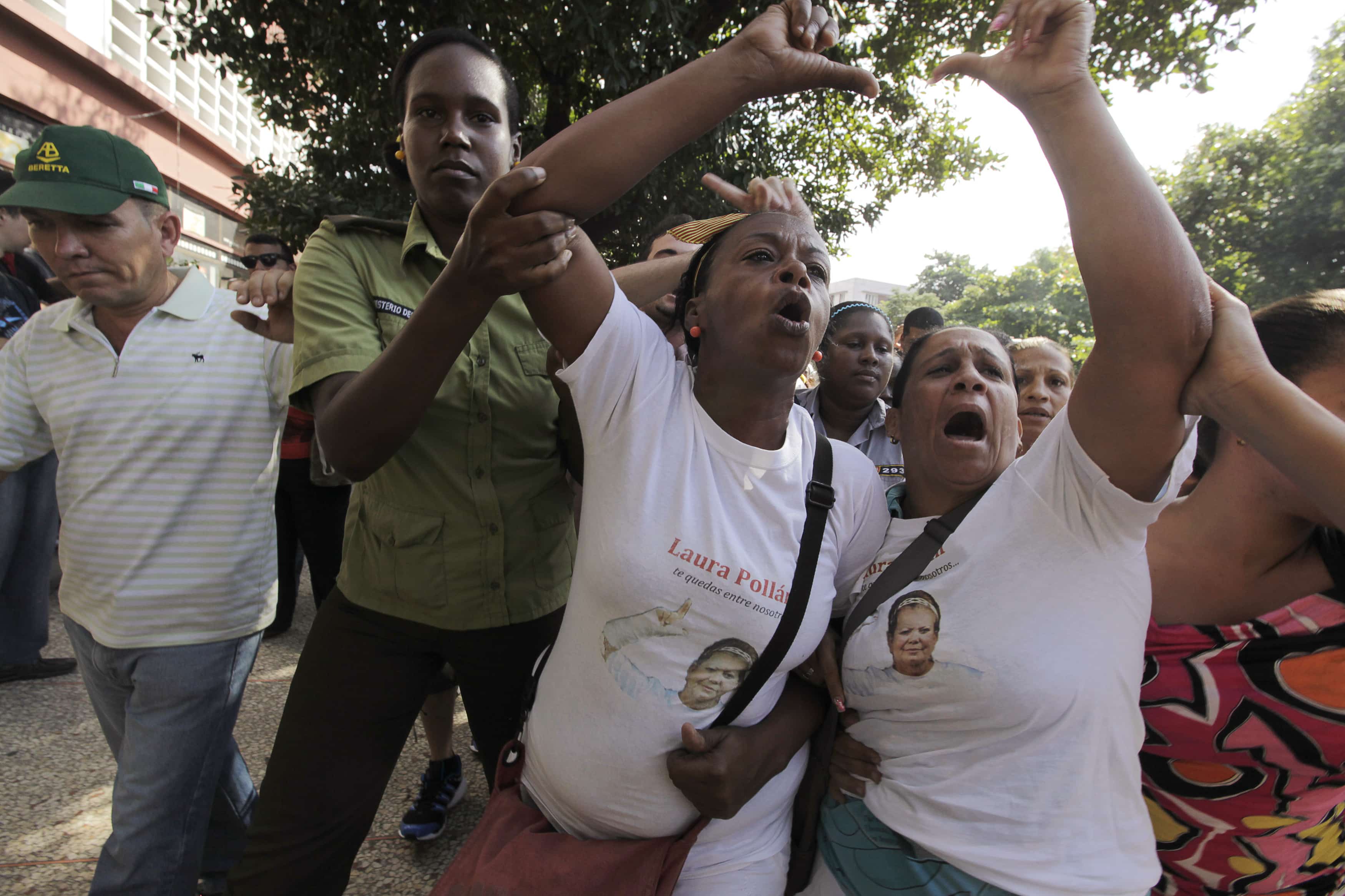 Members of the Ladies in White group shout anti-communism slogans during a protest on International Human Rights Day, in Havana, 10 December 2013. The group is made up of female family members of imprisoned dissidents, REUTERS/Enrique de la Osa