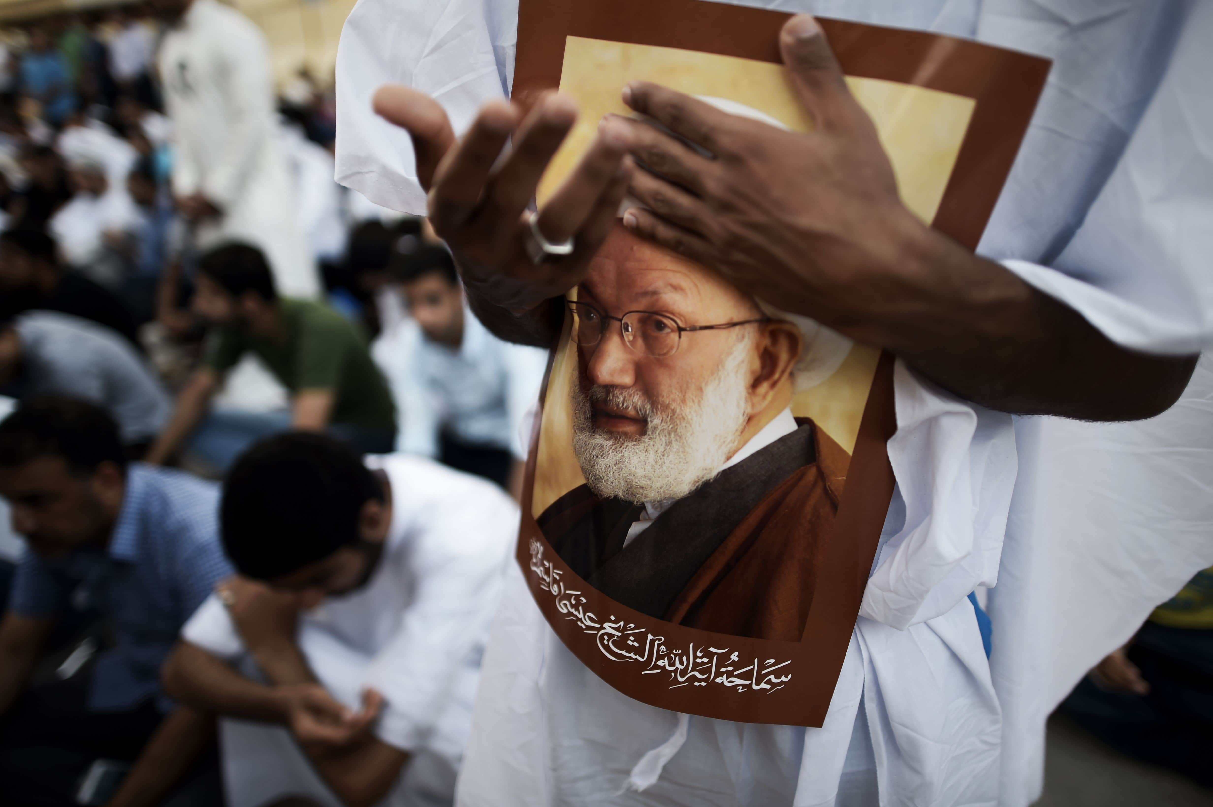 Demonstrators attend a protest against the revocation of the citizenship of top Bahraini Shiite cleric Sheikh Isa Qassim (portrait), Diraz, Bahrain, 20 June 2016, MOHAMMED AL-SHAIKH/AFP/Getty Images