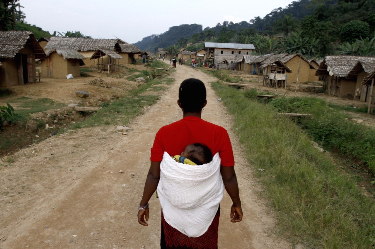 A Congolese woman walks down the main road in the village of Luvungi, near Walikale, Democratic Republic of Congo, 3 September 2010, MARC HOFFER/AFP/Getty Images