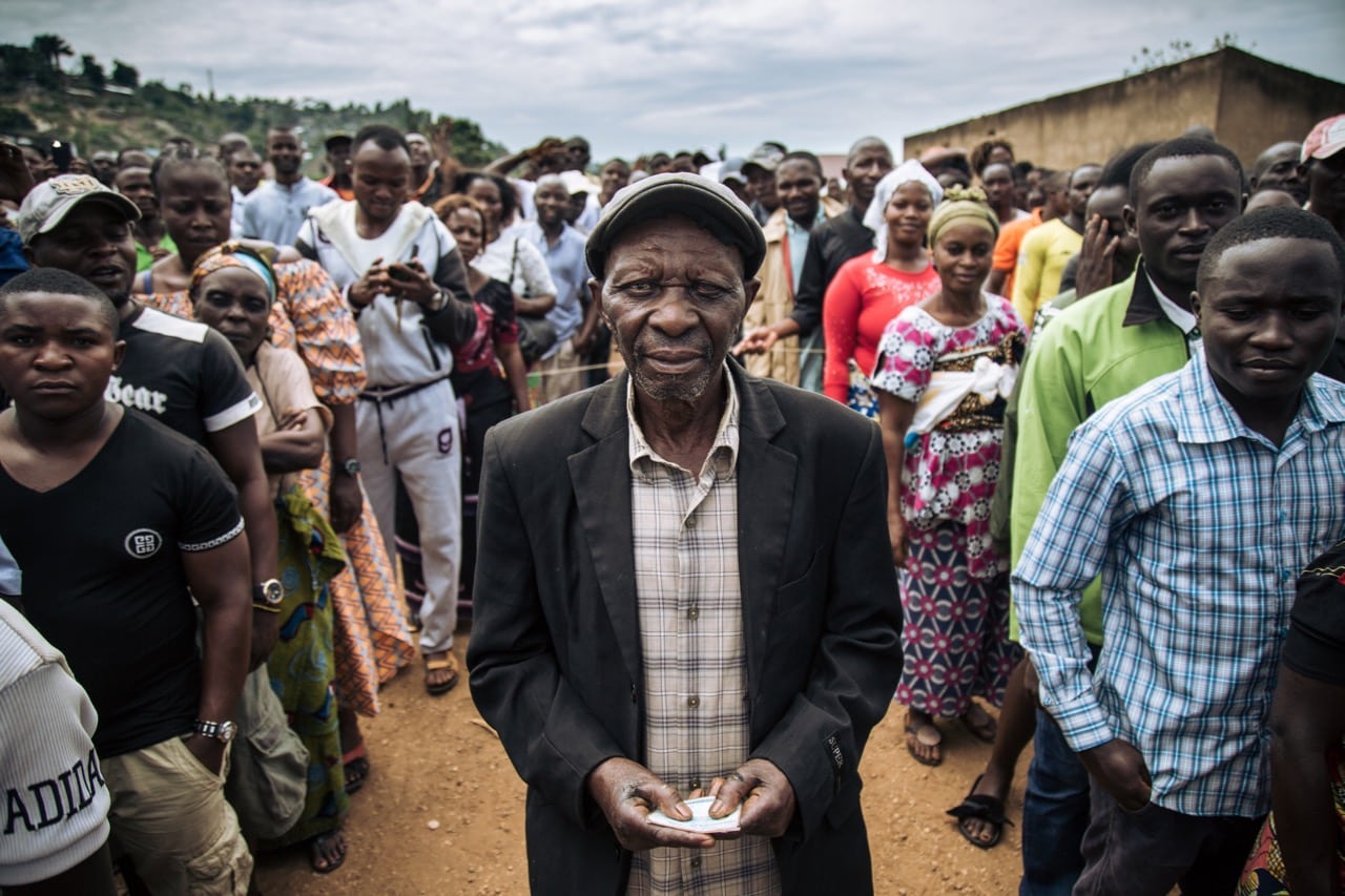 A man holds his voter card after voting at a symbolic polling station at Malepe Stadium in Beni, Democratic Republic of Congo, 30 December 2018, where voting was postponed, ALEXIS HUGUET/AFP/Getty Images