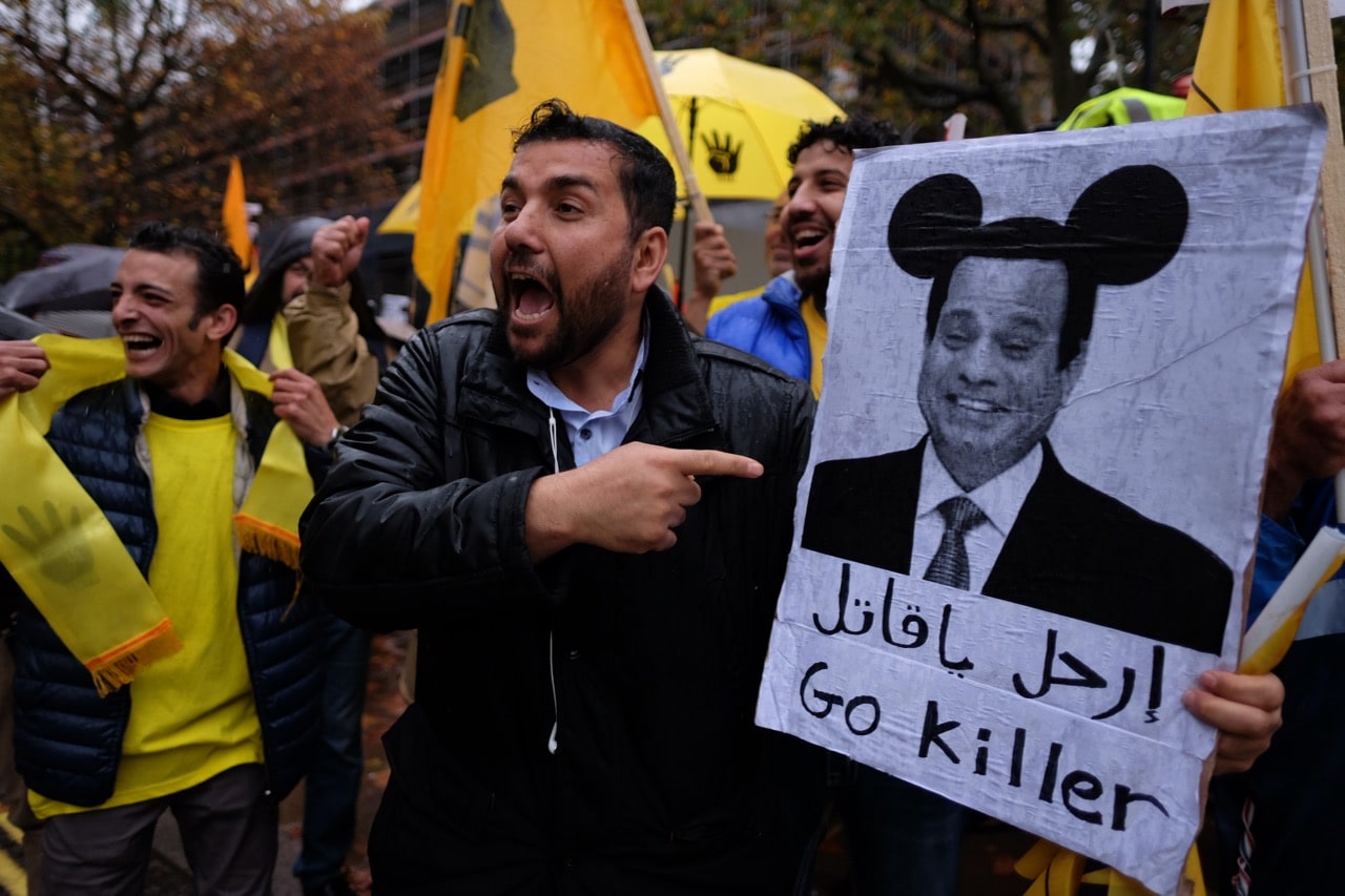 Protesters outside the Egyptian Embassy in London, UK, 5 November 2015; A Facebook user who posted the featured image of President El-Sisi with superimposed Mickey Mouse ears was arrested and sentenced to three years in prison that same year, Alisdare Hickson via Flickr (CC BY-SA 2.0)